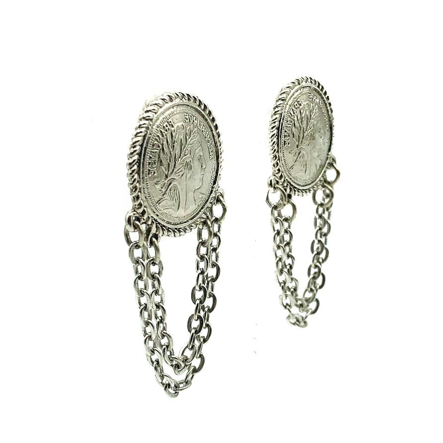 Vintage Coin Earrings. Featuring a French coin style top with garland chains. Crafted in silver'tone metal. In very good vintage condition. 5.2cms. A highly en trend look.

Established in 2016, this is a British brand that is already making a name