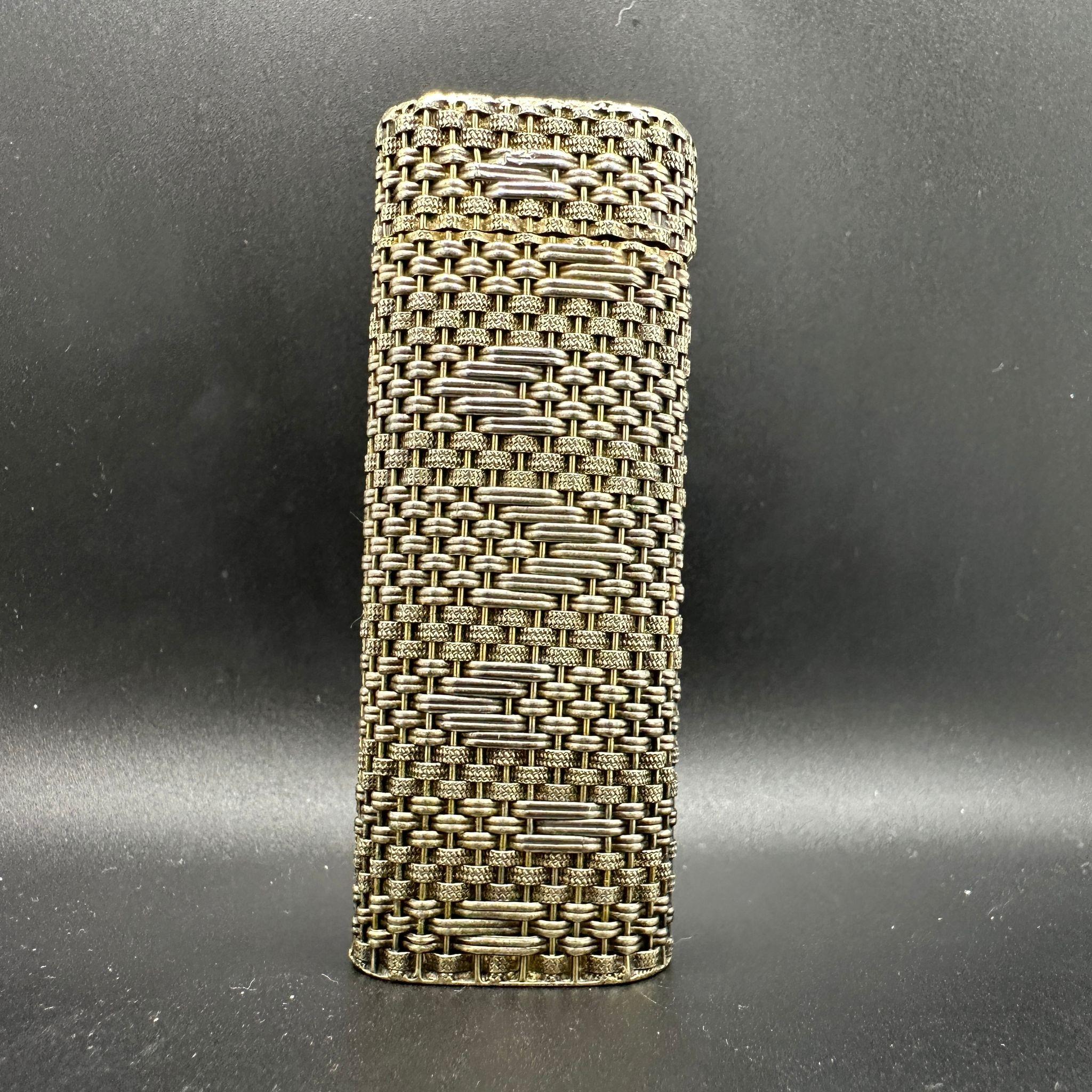 Beautiful and Rare Vintage Silver & Gold Woven Mesh Cartier lighter 
Gold 18 K gold plating and Silver 925
The lighter sparks, ignite and flames 
In mint working and exterior condition. 