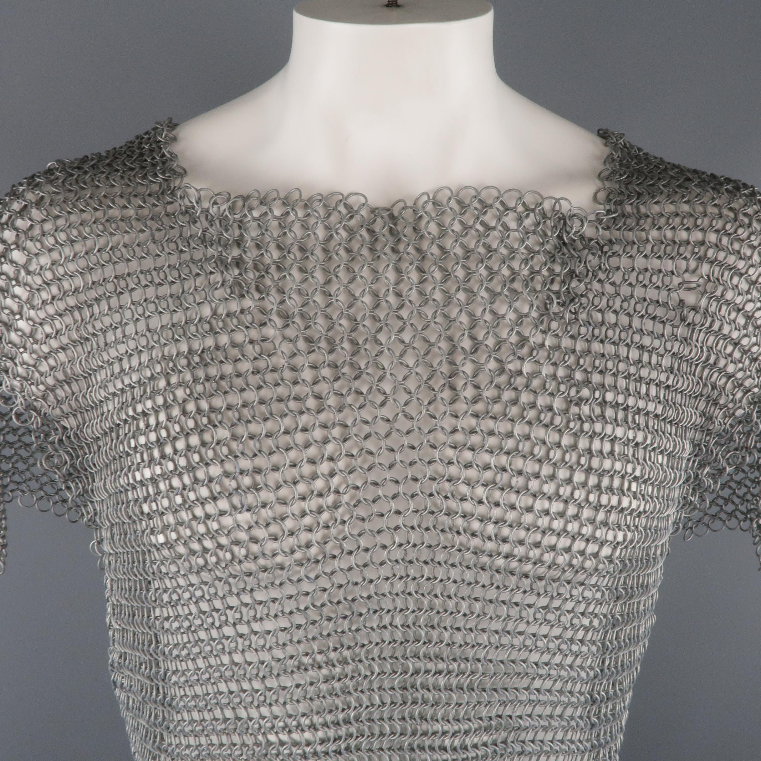 This vintage Medieval style armor top comes in heavy antique liver tone loop chainmail with a square collar, flap sleeves, and oversized silhouette. Very heavy material and some where throughout. As-is.
 
Good Pre-Owned Condition.
Marked: (no size)
