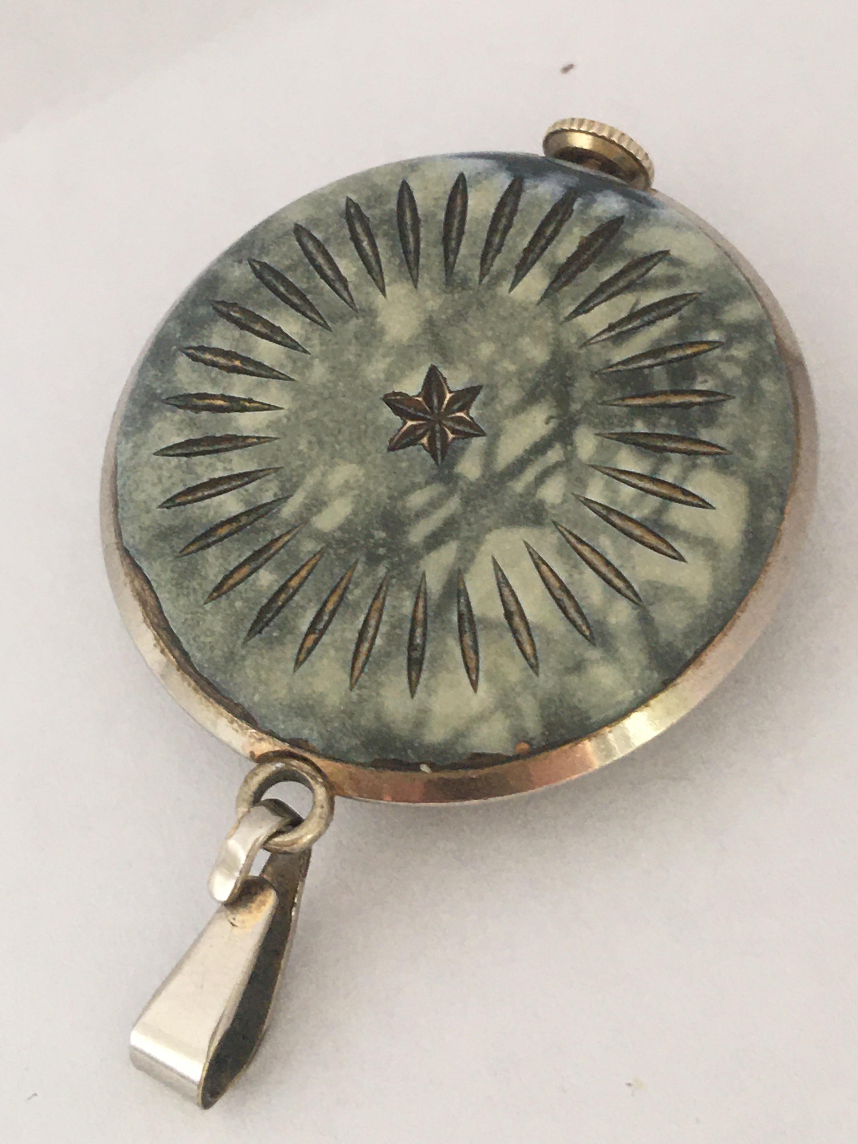 This beautiful vintage hand winding pendant watch is in good working condition and it is running well. It keeps a good time. Visible signs of ageing and wear with some scratches on the glass and on the enamel casing as shown. Some deterioration and