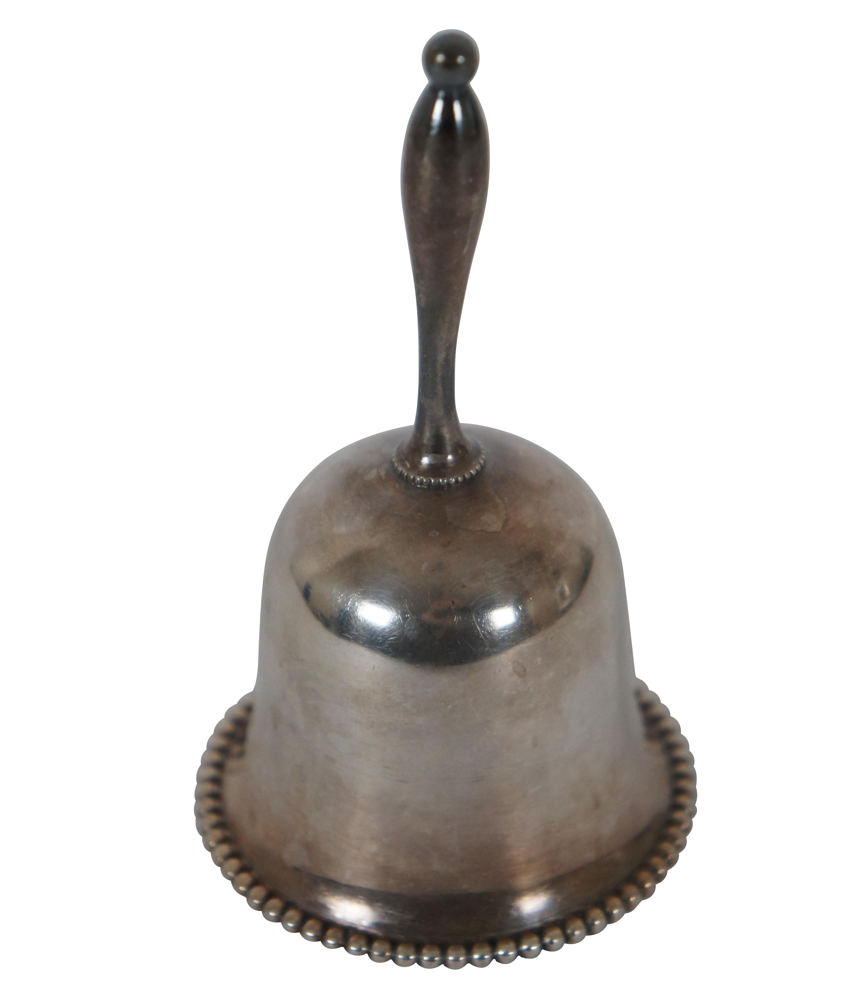 Vintage silver plate hand bell / dinner bell featuring a spindle style handle and beaded opening.