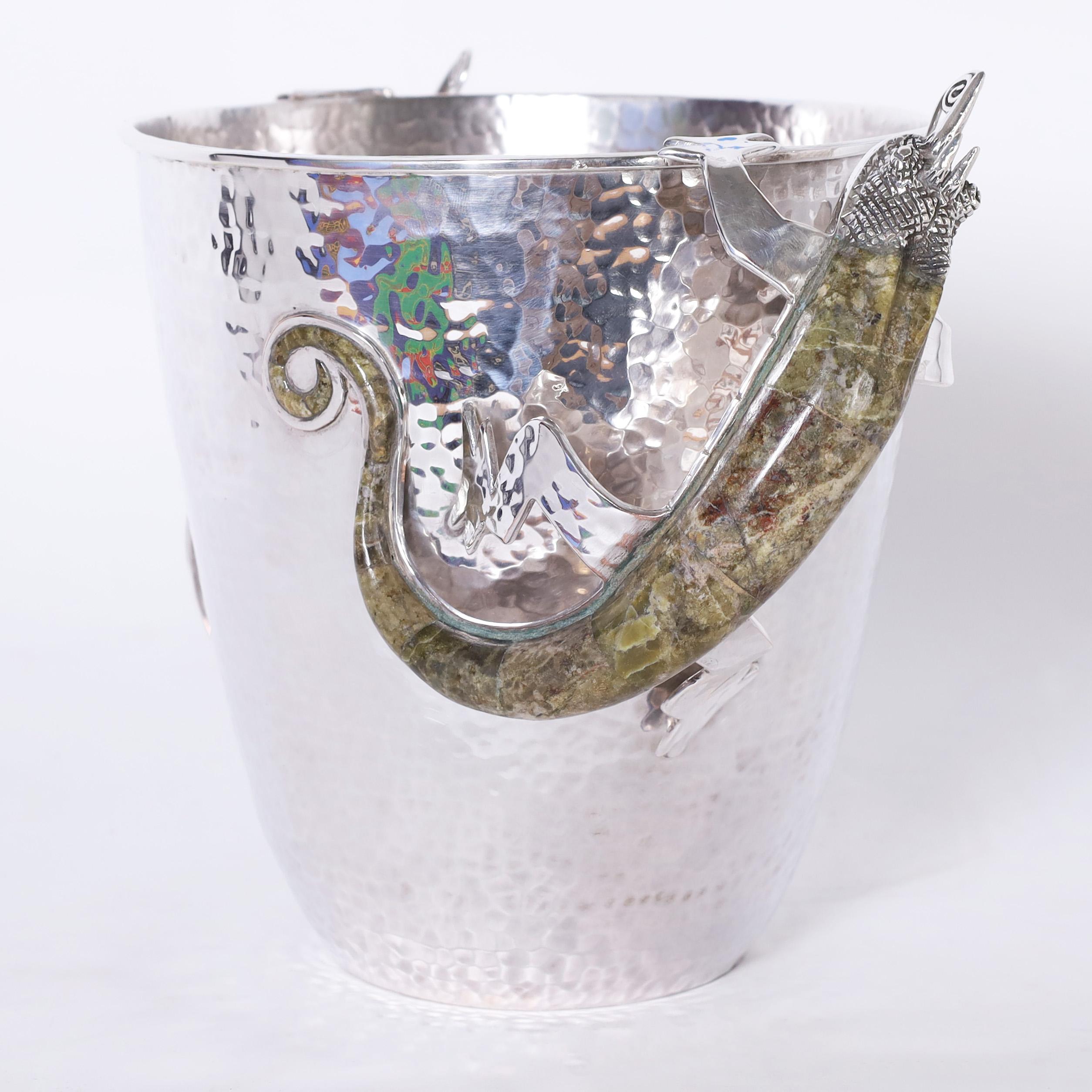 Stand out mid century ice bucket handcrafted in silver plate over copper featuring lizards with stone backs and coiled tongues as handles. Stamped Wolmar Castillo on the bottom.