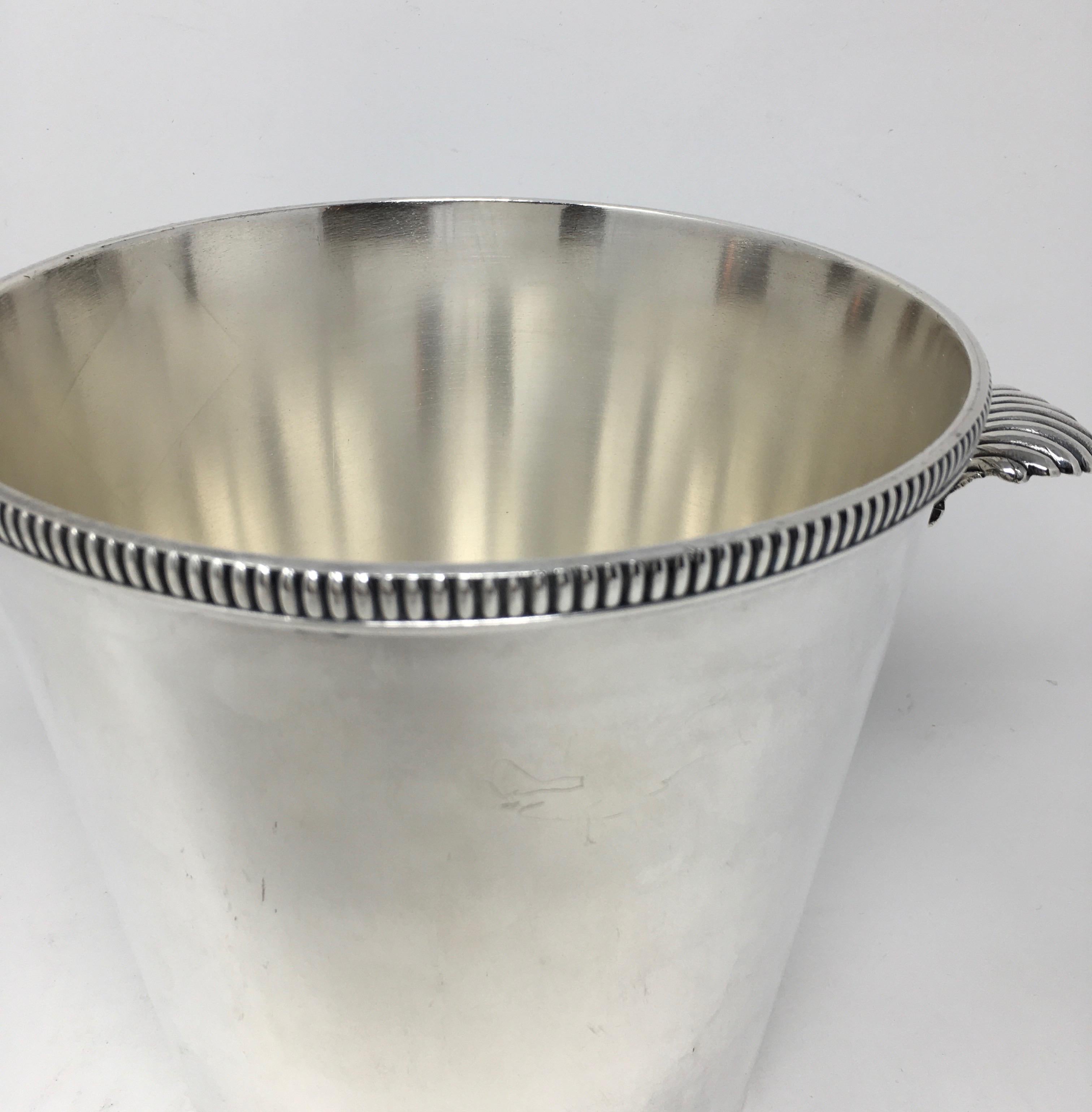 Beautiful vintage silver plate ice champagne bucket with shell shaped handles. Stamped on the bottom.