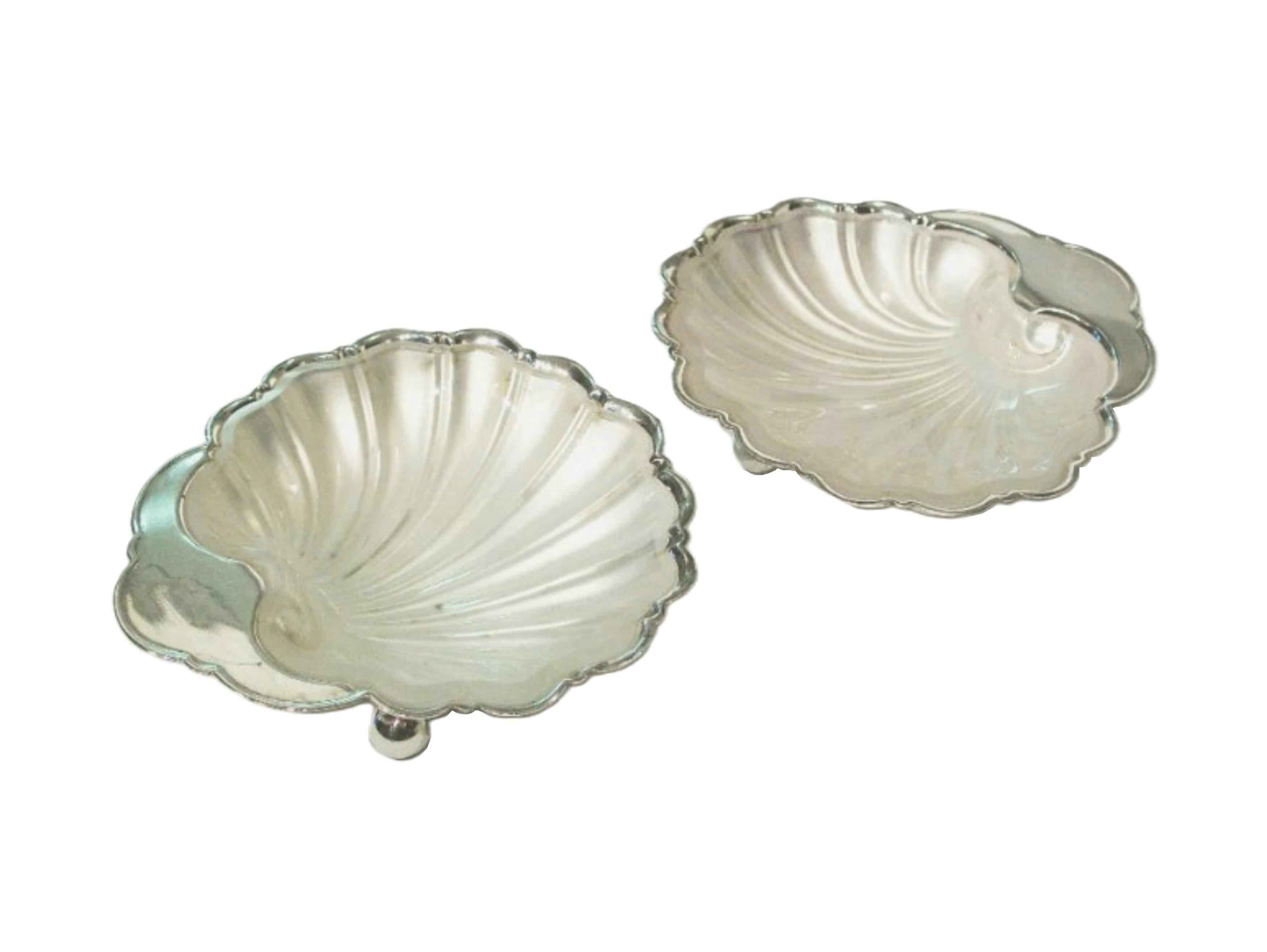 Pair of vintage 'shell shaped' silver plate butter dishes on ball feet - original frosted glass liners - each with model number 1624 - both dishes signed (unknown maker) - United Kingdom - circa 1940's.

Excellent vintage condition - chips to the