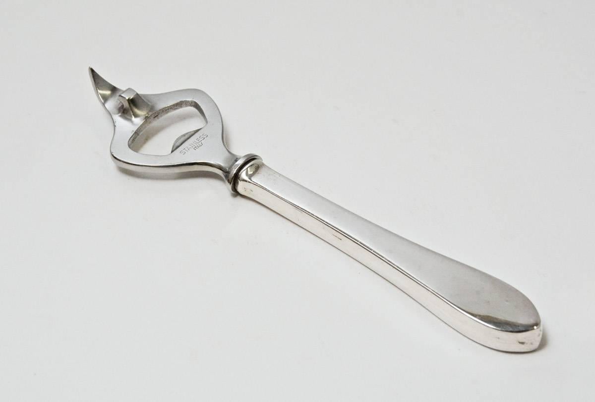 The vintage combined bottle and can opener has a silver plated handle and stainless steel opener. Stamped Stainless, Italy.