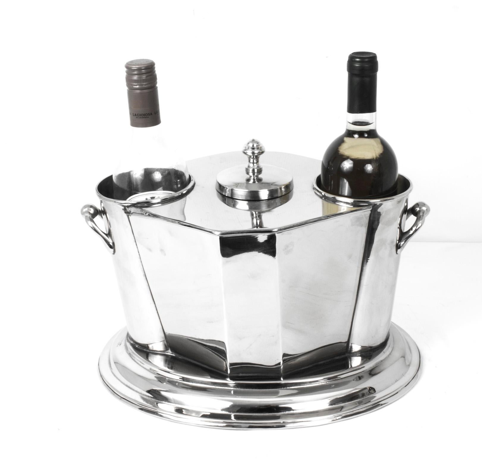 This is a beautiful silver plated wine cooler in elegant Art Deco style.

A lidded section for crushed ice sits between the two crafted bottle compartments, making sure your bottles are at the perfect serving temperature.

This wine cooler is
