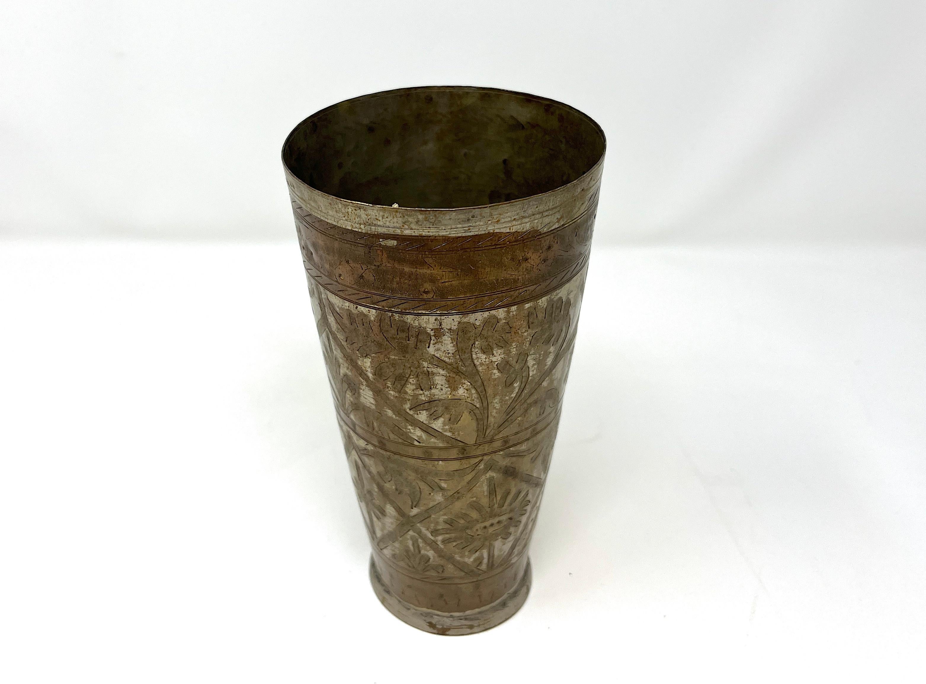 Hand hammered silvered metal and brass engraved beaker beautifully hand chiseled and decorated with geometrical and botanical patterns. One-of-a-kind old Islamic Mughal style lassi drinking cup from India, beautifully hand etched by artisan. The