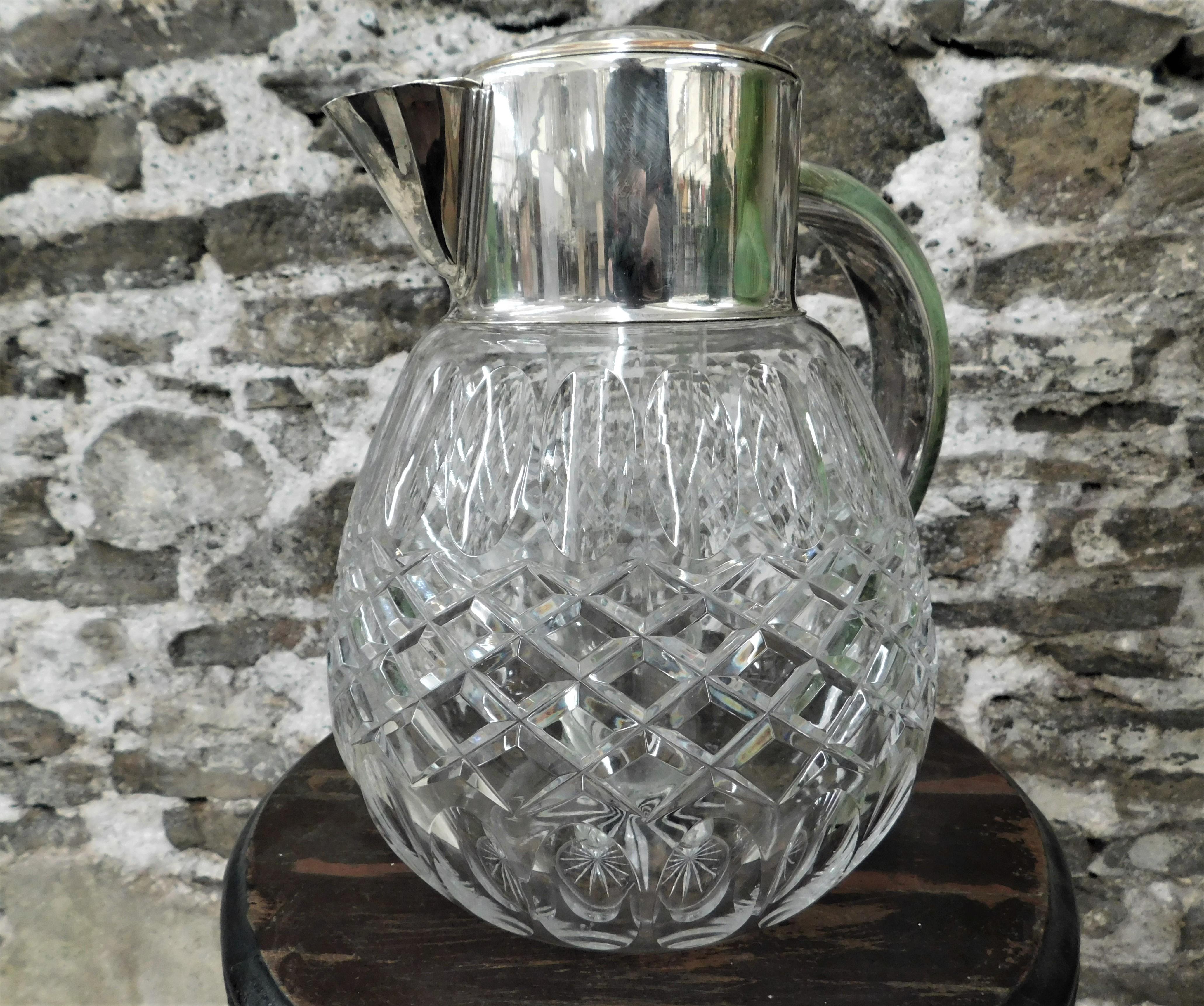 Beautiful 1940's silver plated hand cut crystal glass juice/punch/liquor pitcher/jug/decanter with ice cube chiller. Center portion screws into lid for ice placement and has cork inserted in lid, cools your beverage without diluting it.