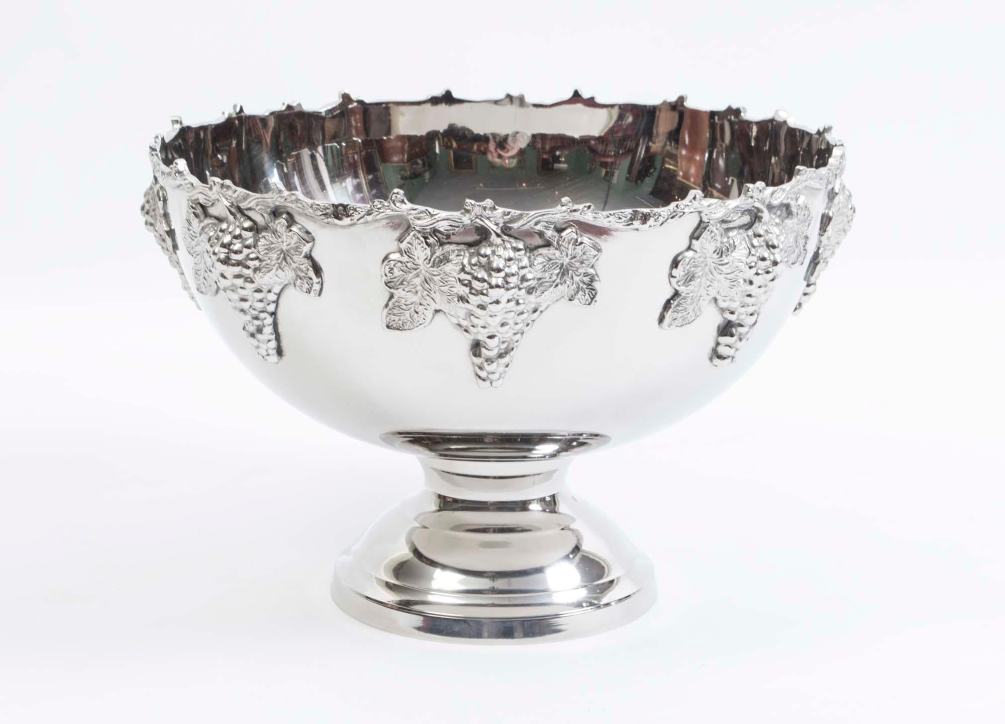 This is a gorgeous vintage silver plated Monteith champagne cooler dating from he late 20th C 

Around the top of this exquisite punch bowl are bunches of grapes that are connected by twisting vines which are flanked by leaves. This beautiful