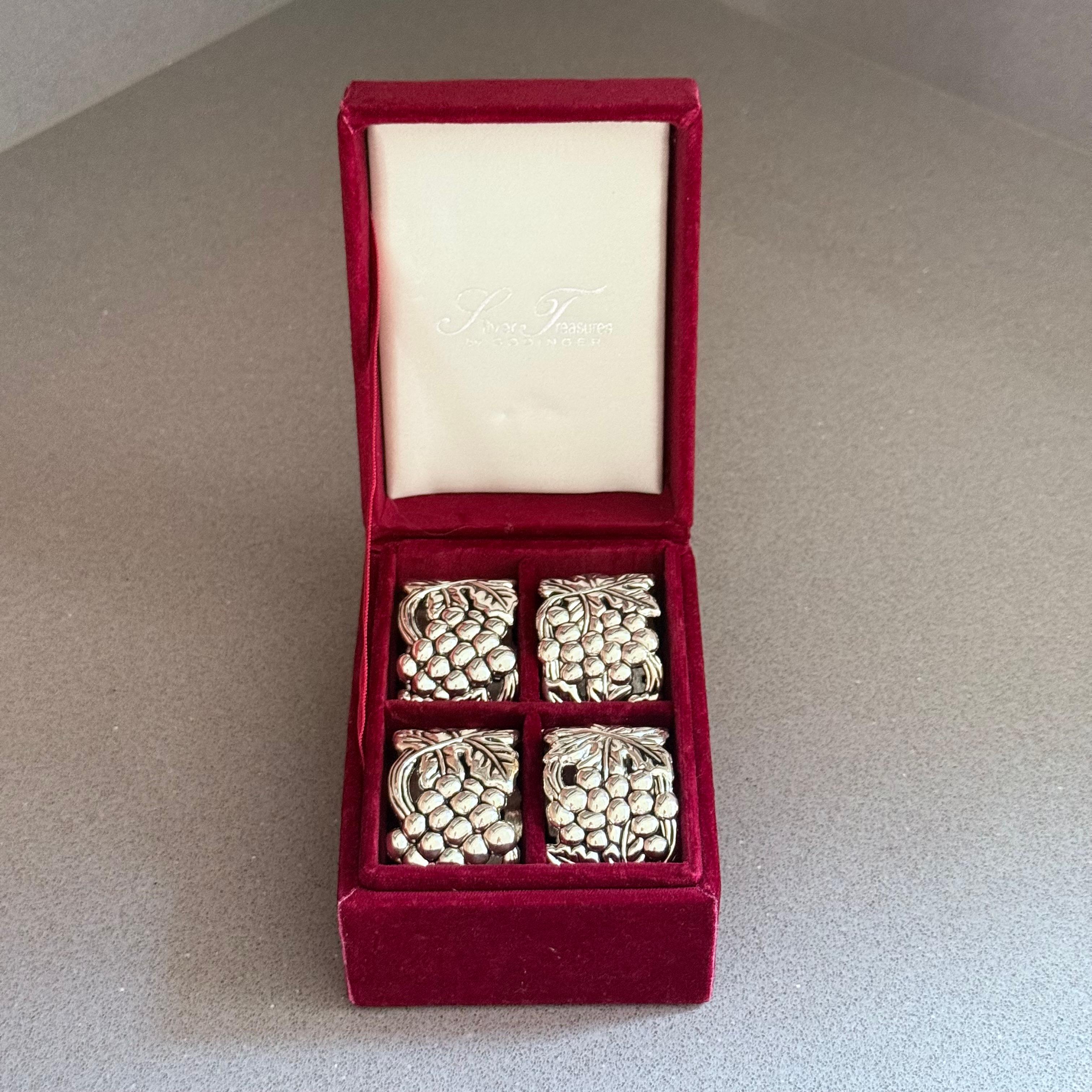 Add elegance and charm to your dining table with this set of 4 antique English style silver plated napkin rings, beautifully presented in their original red velvet fitted case. Each ring is finely detailed with an ornate grape and vine design,