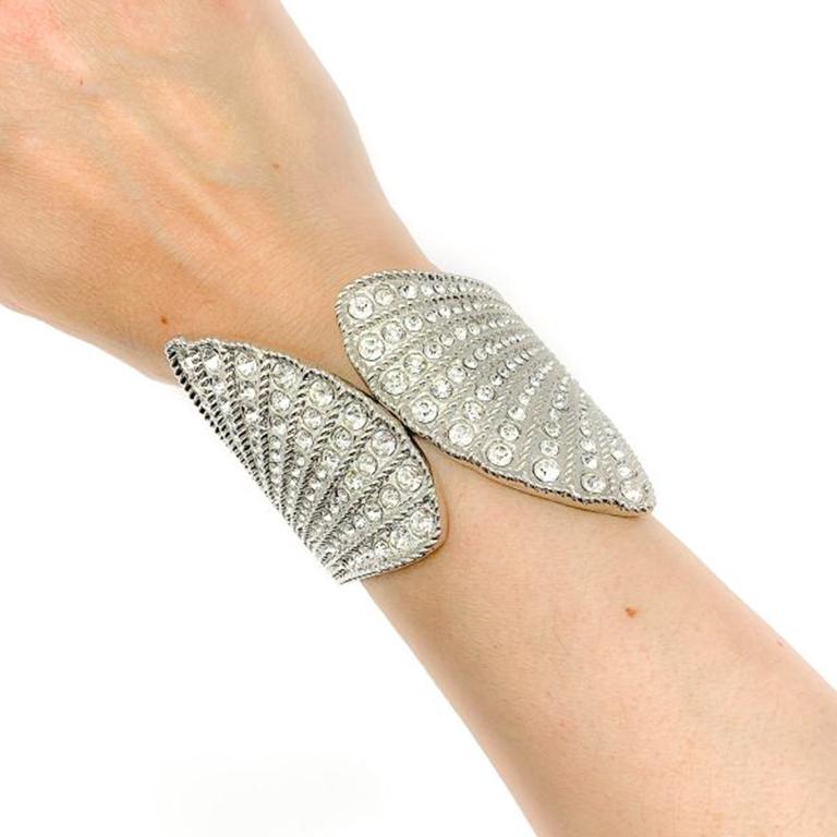 A striking Vintage Rhinestone Clam Cuff of statement proportions. Crafted from silvertone metal and set with a fabulous array of sparkling rhinestones. 8 cm deep, in very good vintage condition. A stunning piece of arm candy that will work with