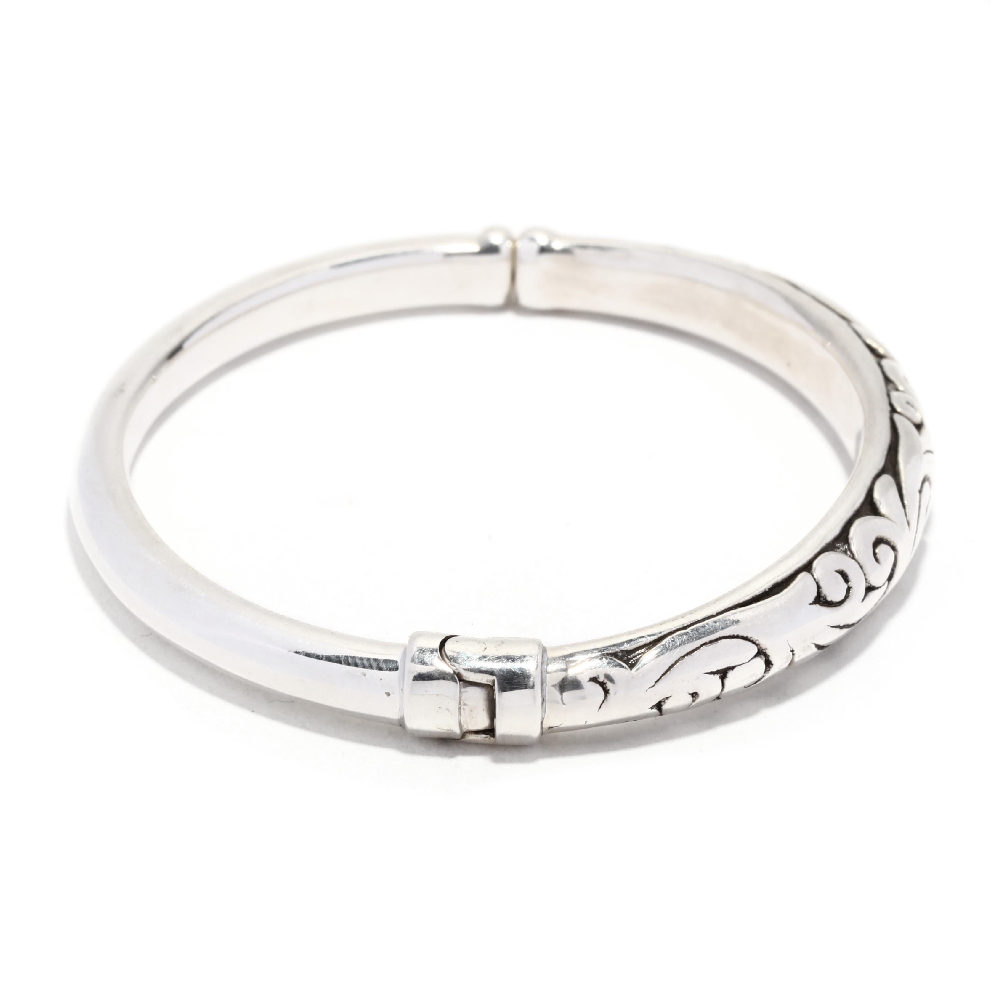 This vintage silver scroll bangle bracelet is the perfect addition to any jewelry collection! Crafted from sterling silver, this bangle measures 6.75 inches in length for a comfortable fit. The unique scroll design makes it perfect for stacking with