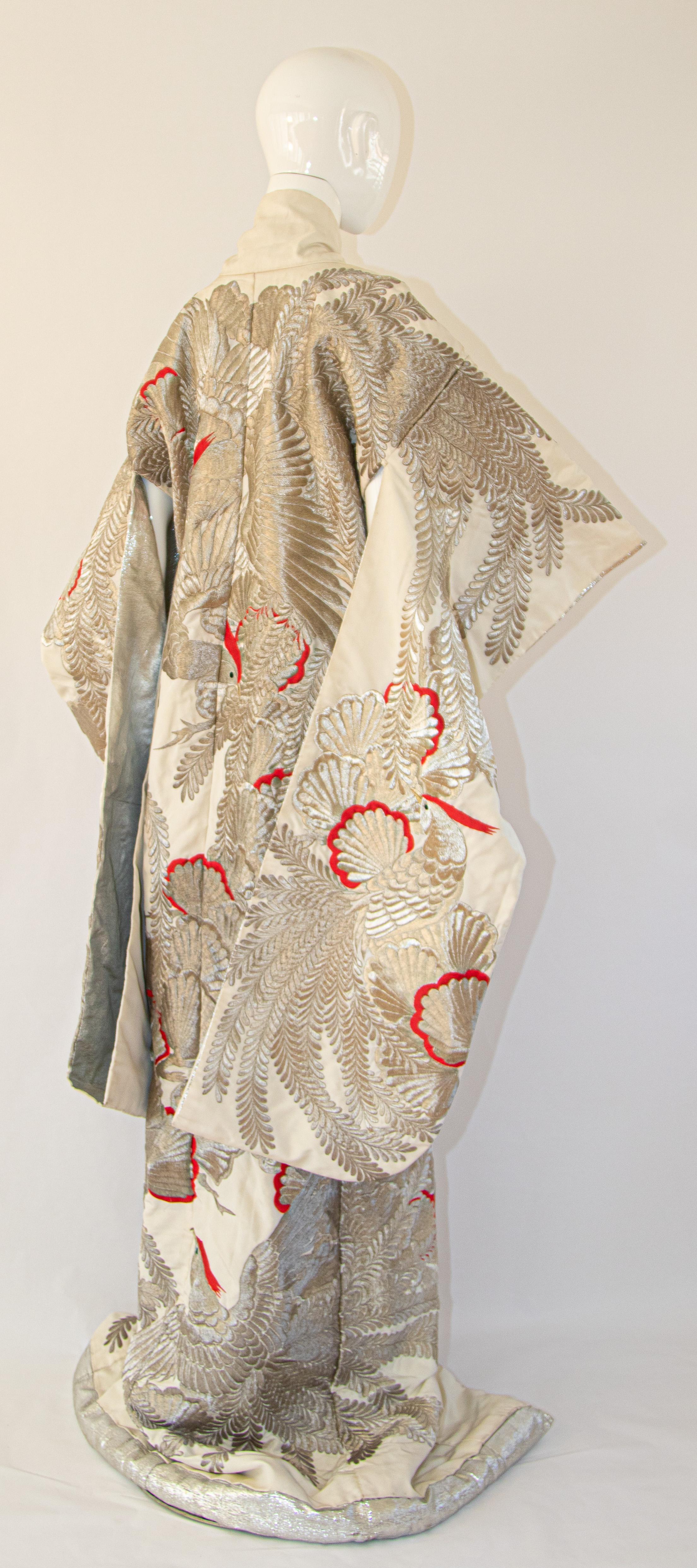 A vintage midcentury ivory and silver thread silk brocade collectable Japanese ceremonial wedding kimono.
One of a kind handcrafted fabulous museum quality ceremonial piece in pure silk with intricate detailed hand-embroidery throughout accented