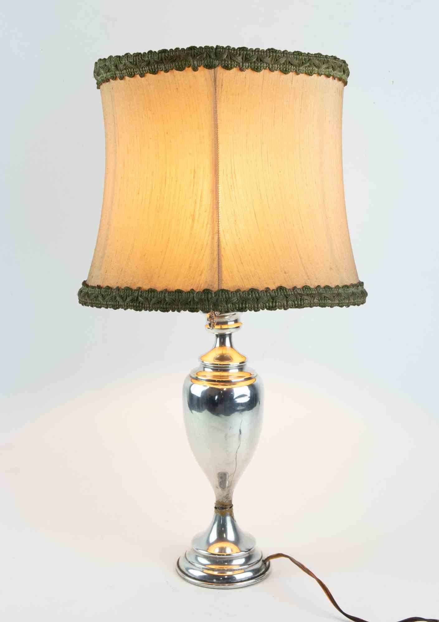 Lampe de table vintage en argent réalisée en Italie au milieu du 20ème siècle.

Diamètre : sommet 20 cm ; base 7 cm

Poids : 0,626 kg

Bon état.


