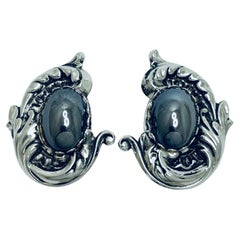 Used silver tone designer clip on earrings