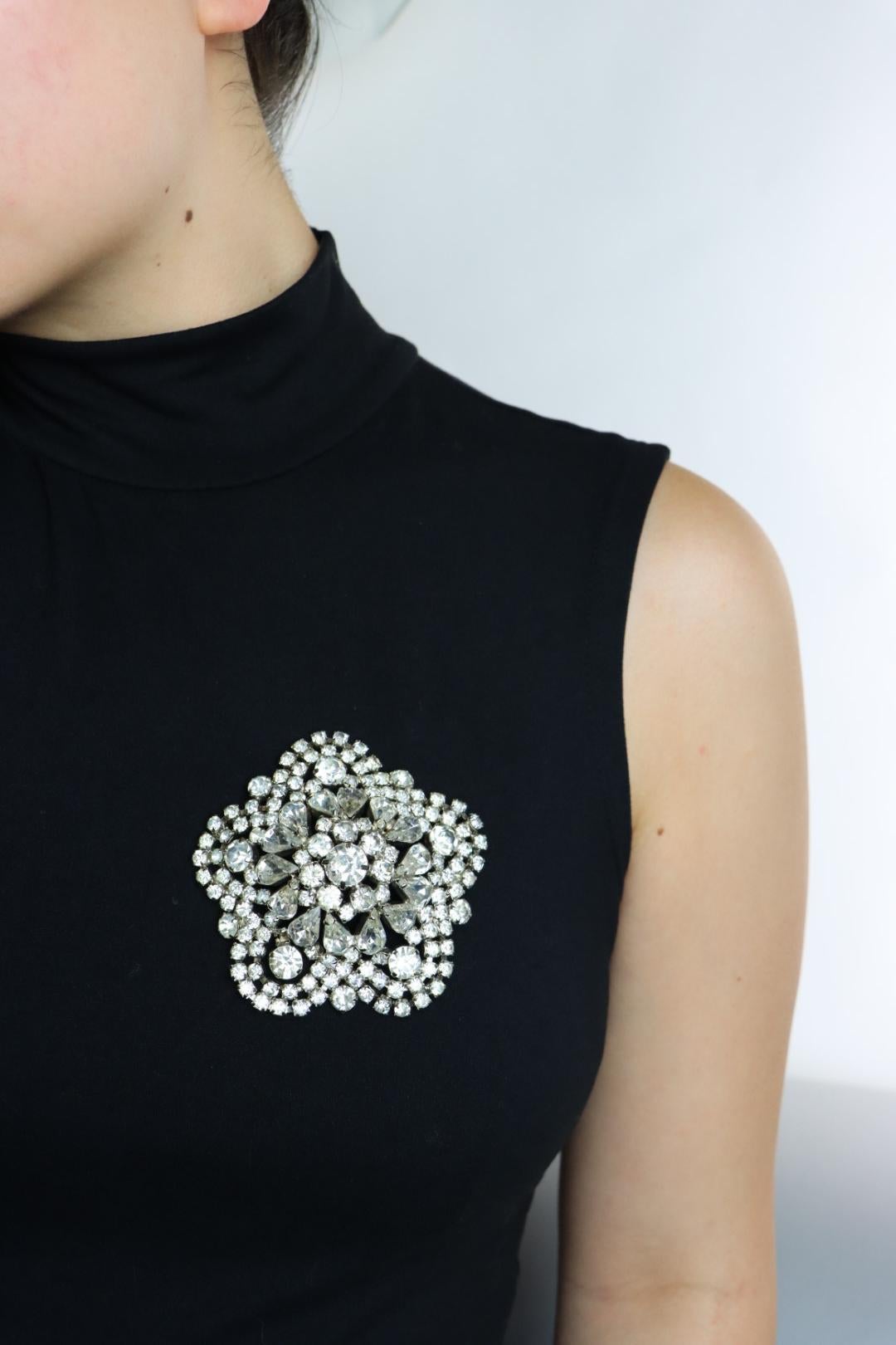 Vintage Silver Tone Rhinestone Flower Brooch Pin

Approximate Dimensions:
7.6 cm (Diameter) 
52.2 grams in weight.