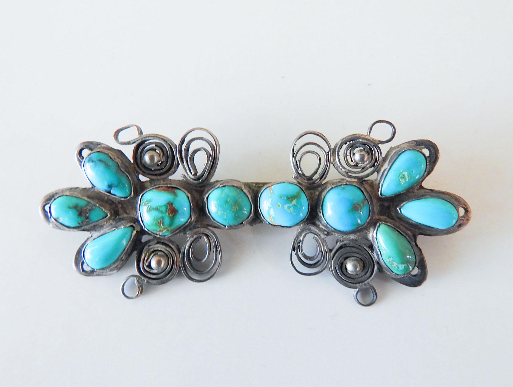 Vintage circa 1960's artistic handmade silver and turquoise Native American brooch.  Filigree design using silver strips quillwork, bezel set hand formed turquoise cabochons. Unmarked, handmade pin and hook finding on back, overall patina, 2.5