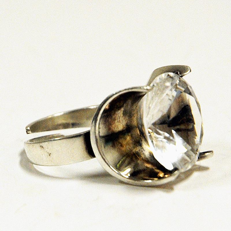Adjustable silvering with an amazing brilliant cut rock crystal stone made by Martti J Hyvärinen for Sirokoru, Finland, 1975. Finland. Great midcentury ring with its beautiful clear stone in the middle. Solid half circle silver base. The ring is