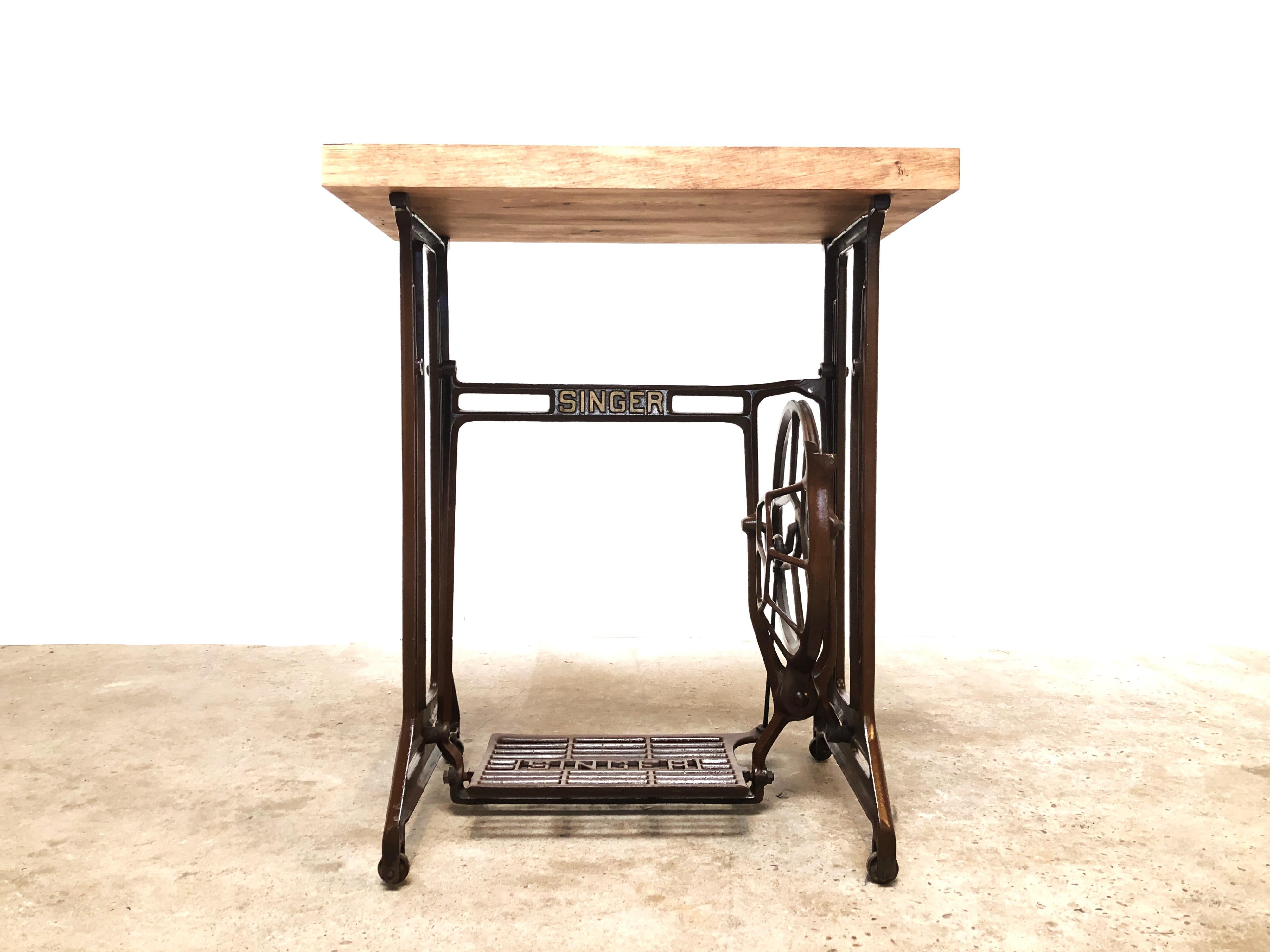 An original Singer sewing machine treadle stand with a reclaimed wood top.

High-quality metal stand from the 1930s. Made by the Singer Manufacturing Company, in the Kilbowie factory, Clydebank, Scotand.

The fitted reclaimed top has been waxed