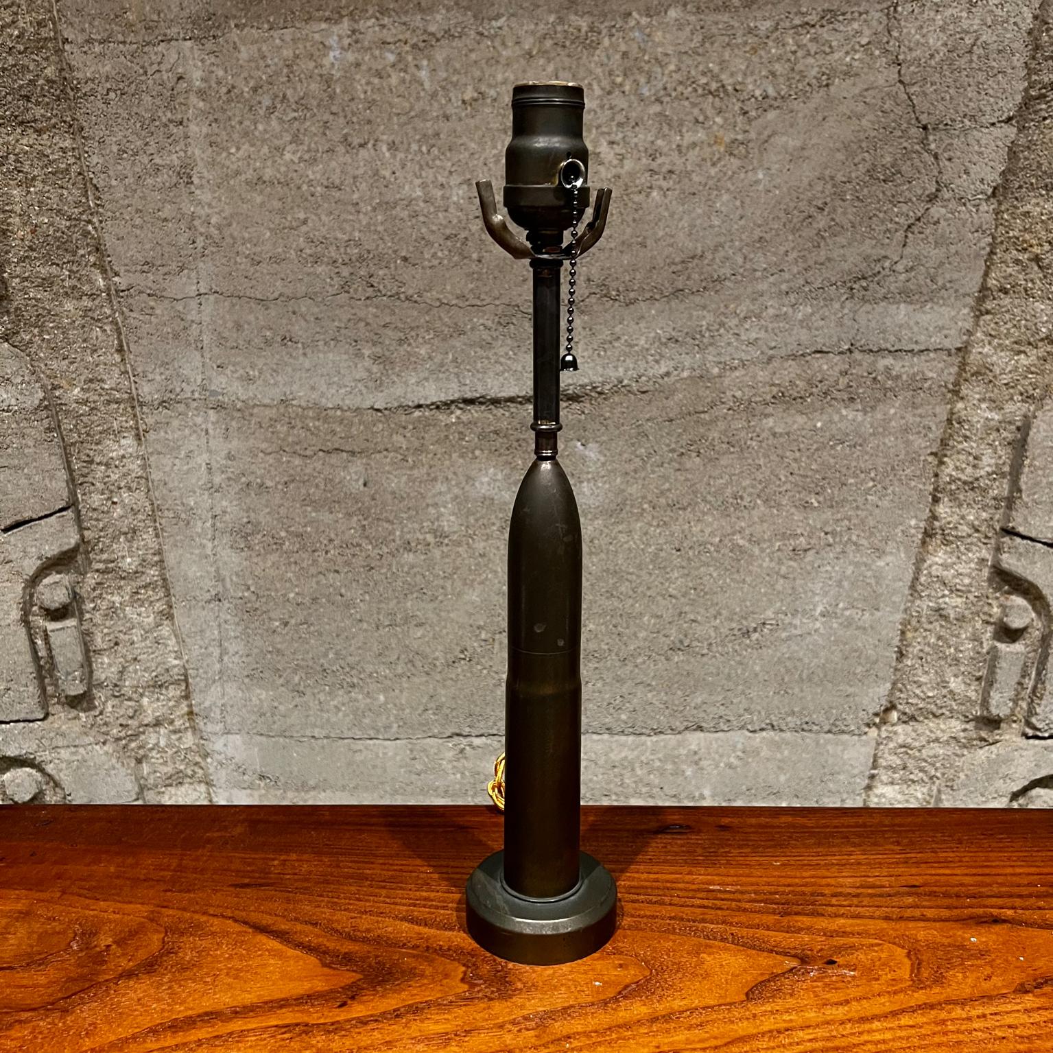 Vintage single table lamp military bullet artillery shell
designed in patinated bronze
No shade is included.
Original unrestored condition with vintage patina.
Measures: 16.5 tall x 3.25 diameter
See images provided.
 