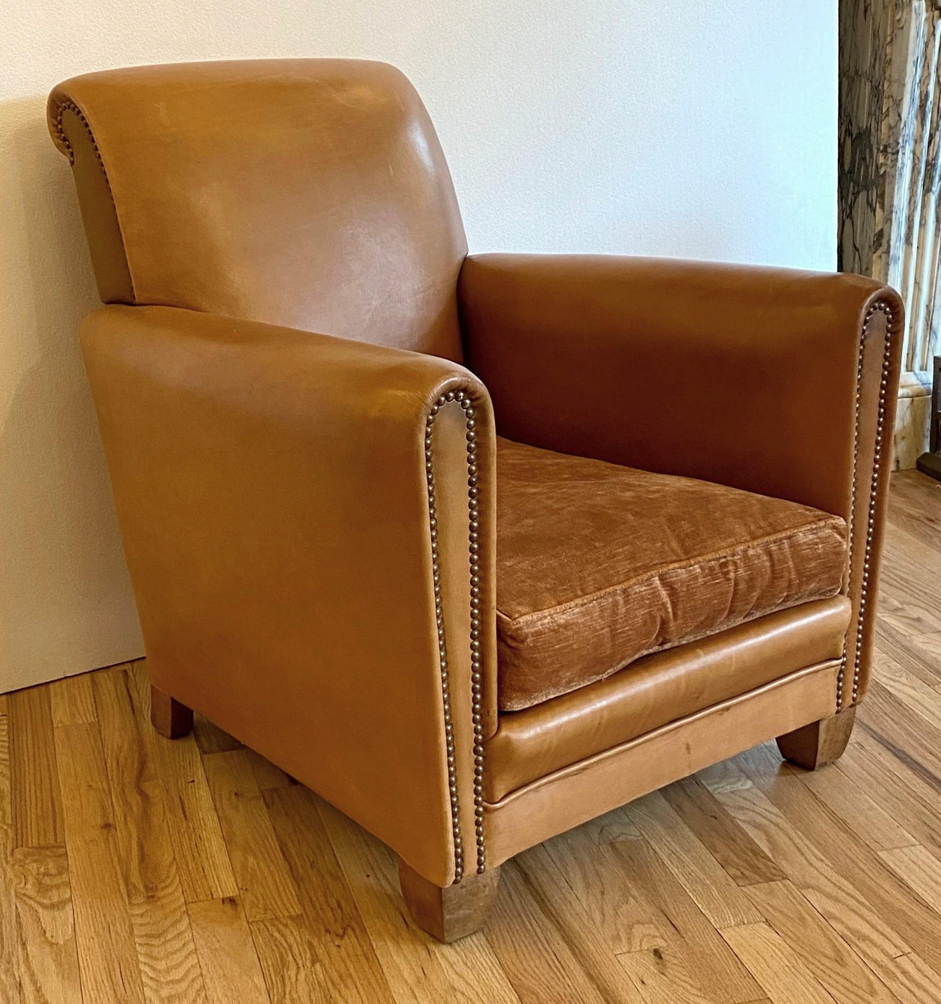 Art Deco 1930s vintage French leather club chair with brass studded arms in refurbished condition. One available. The seat on this chair was neatly redone with a matched mohair upholstery. This can be seen at our 333 West 52nd St location in the