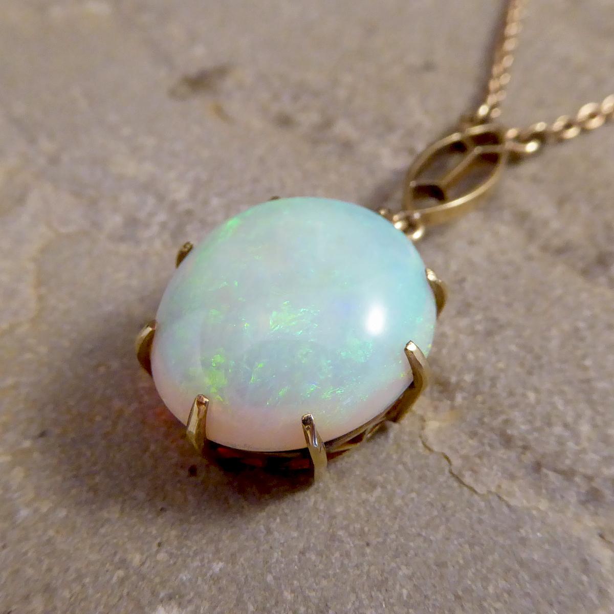 Such a lovely unique vintage Opal pendant, with such exquisite colour, showing blues, oranges and greens throughout, this beautiful piece been crafted from 9ct Yellow Gold with a claw setting. This pendant is worn as a necklace on a 9ct Yellow Gold