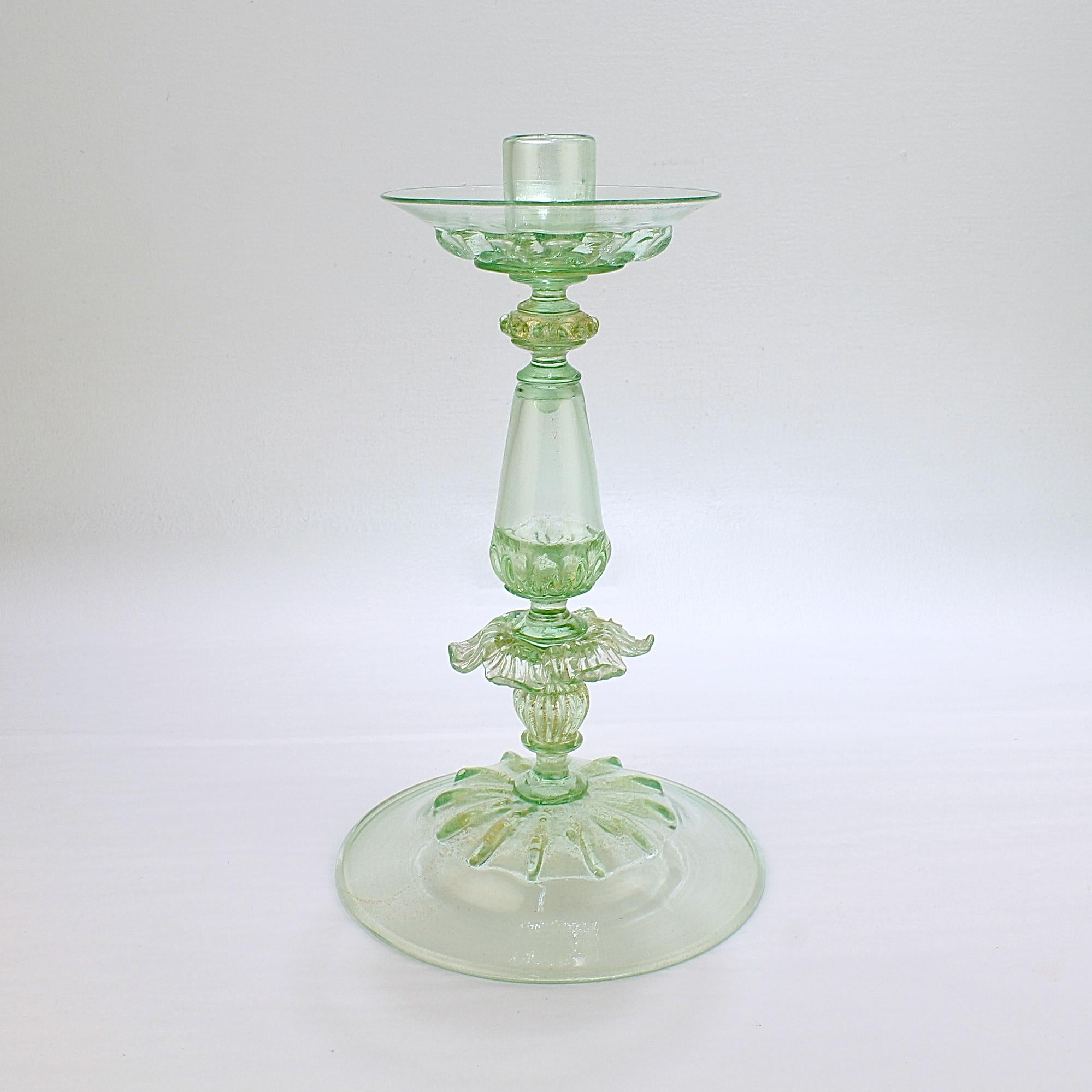 A fine Venetian glass candlestick. 

Attributed to Salviati.

 In lime green (almost uranium colored) glass with gold foil inclusions throughout.
 
With stylized floral decoration to the pedestal. 

Simply a wonderful large scale Venetian