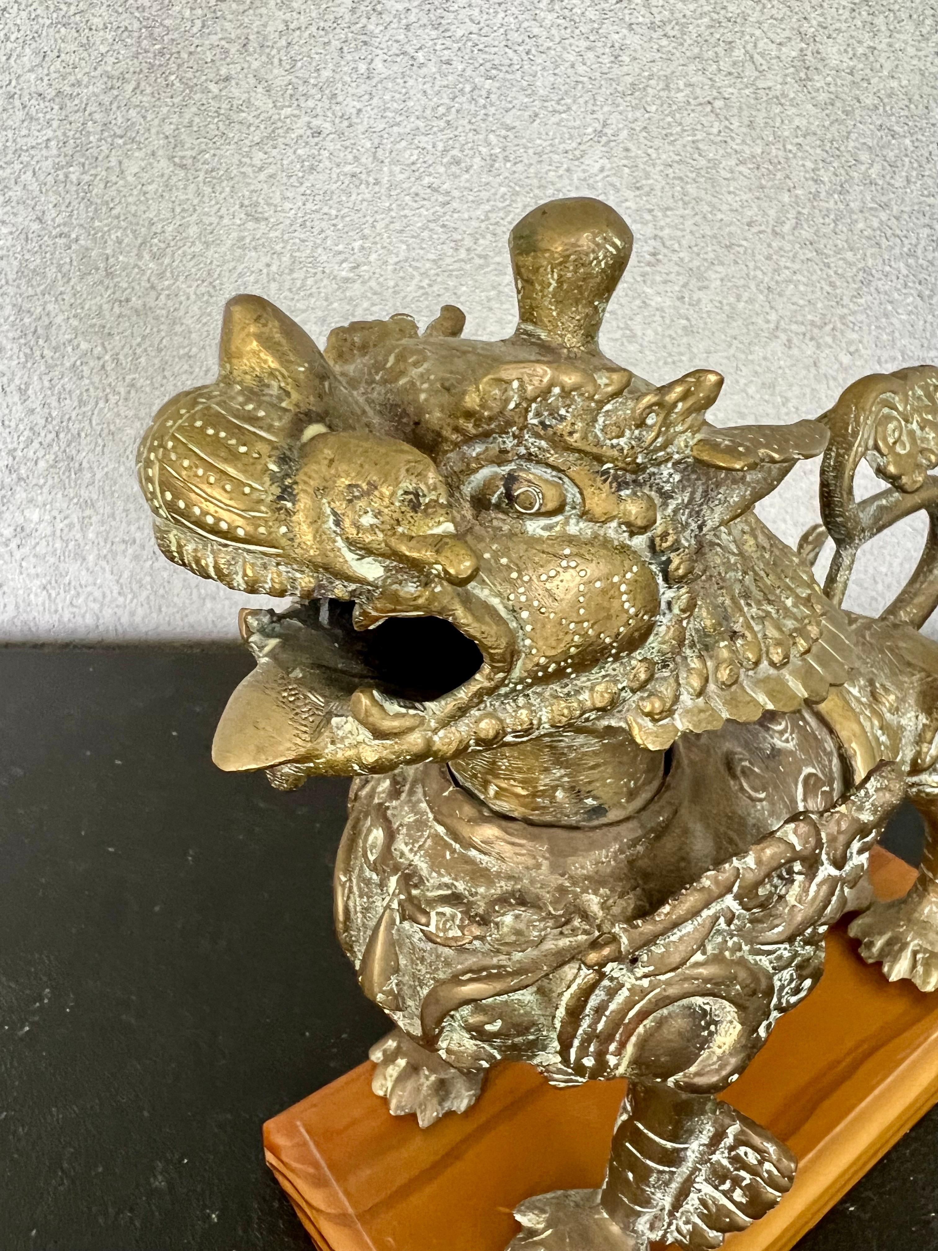 Amazing vintage solid bronze Tibetan Foo dog/Lion has a wooden base that it’s not fixed to the sculpture 
It’s a heavy and extremely detailed piece that would look spectacular on any decor 
Style
weights 4.6 pounds without the base.