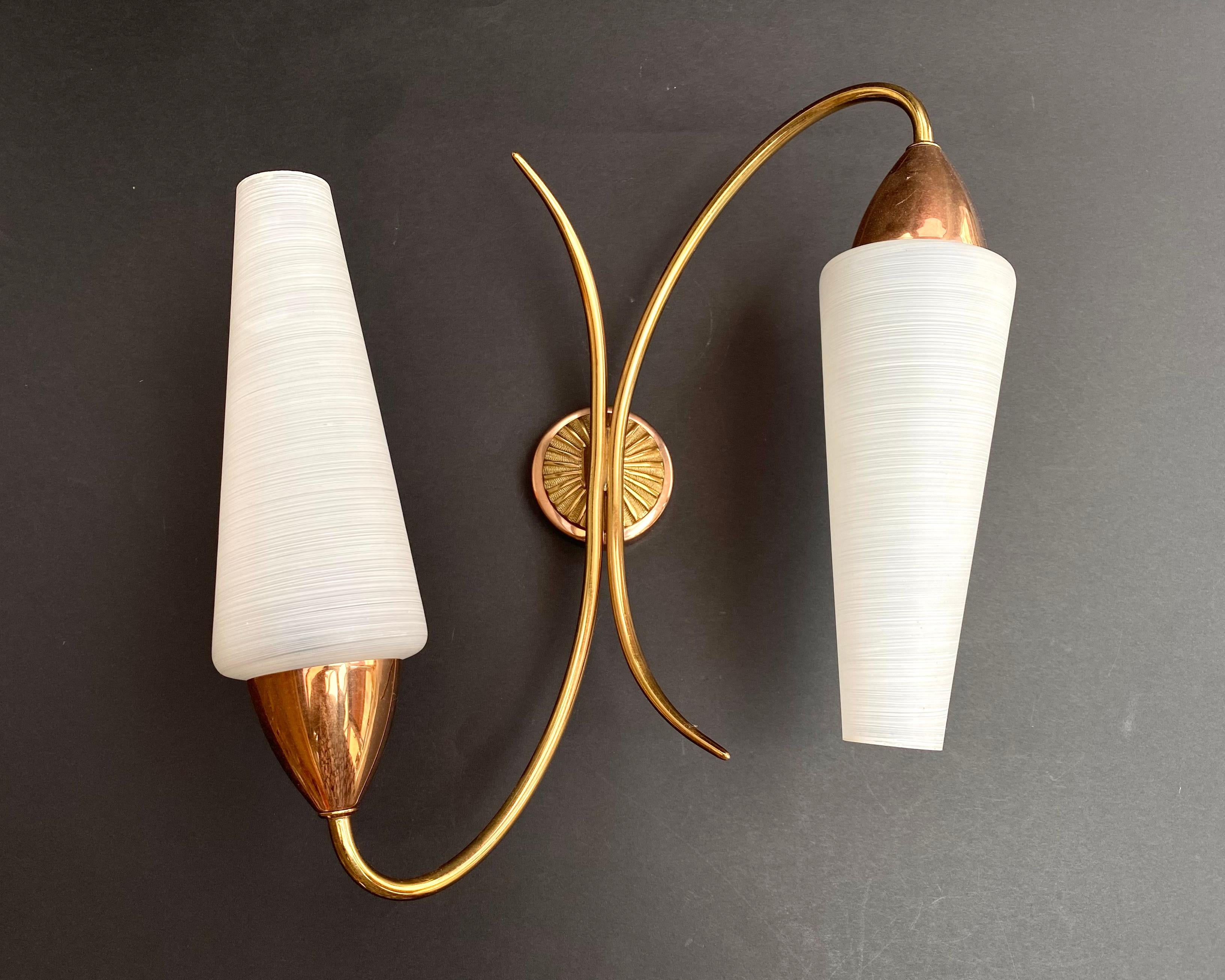 Beautiful French wall light with two diffusers made of matte art glass, brass and copper.

The white glass diffusers help to increase the light.

A stylish wall sconce will easily add a touch of elegance to your home, transform the home space and