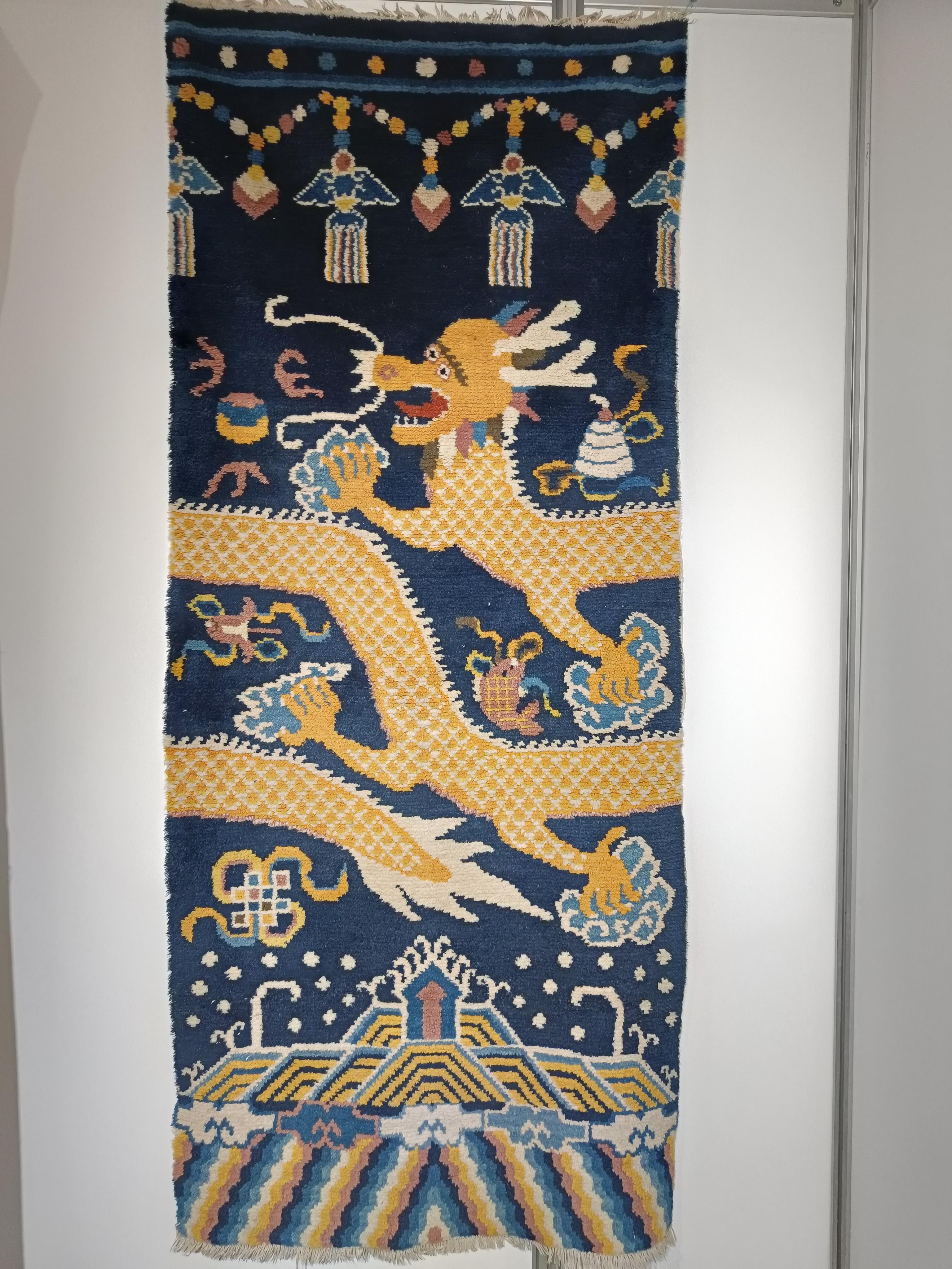  
Vintage Sino Tibetan Dragon rug carpet China Asian 
A fine Tibetan vintage wool dragon rug with a Temple scene with hanging lanterns a yellow dragon encircling on a blue background.
Period mid 20th century
Size 185 x 90cm
Condition fine
