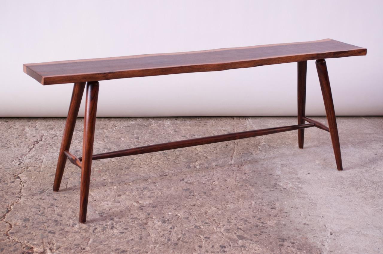 Solid sissoo (North Indian rosewood) live edge table / bench on turned legs, circa 1980s. Given its narrow size, it is suitable for hallway / foyer, sofa or boudoir use.
Newly refinished condition free of flaws.
Measures: H 18.1