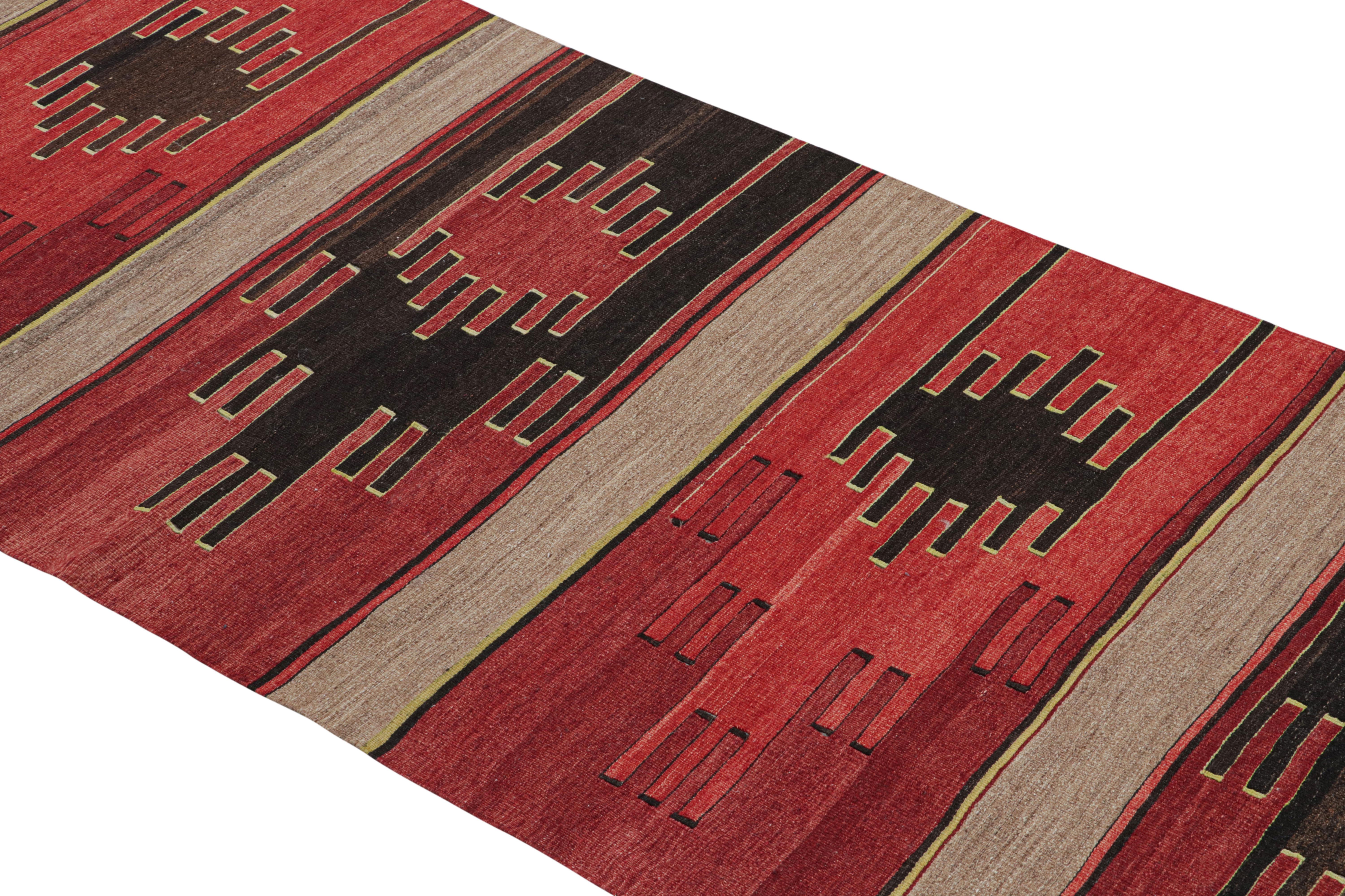 Flat-woven in high-quality wool originating from Turkey between 1930-1940, this vintage Sivas Kilim rug blends a tasteful, Classic geometric pattern with a rich tribal variation of tangerine and burgundy red, yellow, and unique black colorways along
