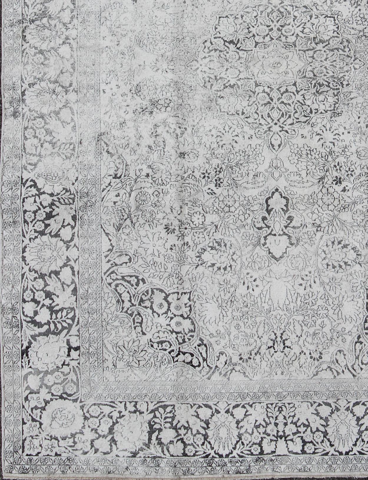 Measures: 7'1 x 10'3.

Sivas rugs are products of the Sivas province in central Turkey. This particular piece is characterized by a palette of cool colors such as light gray and blue. The border, which consists of a floral, leafy motif, frames