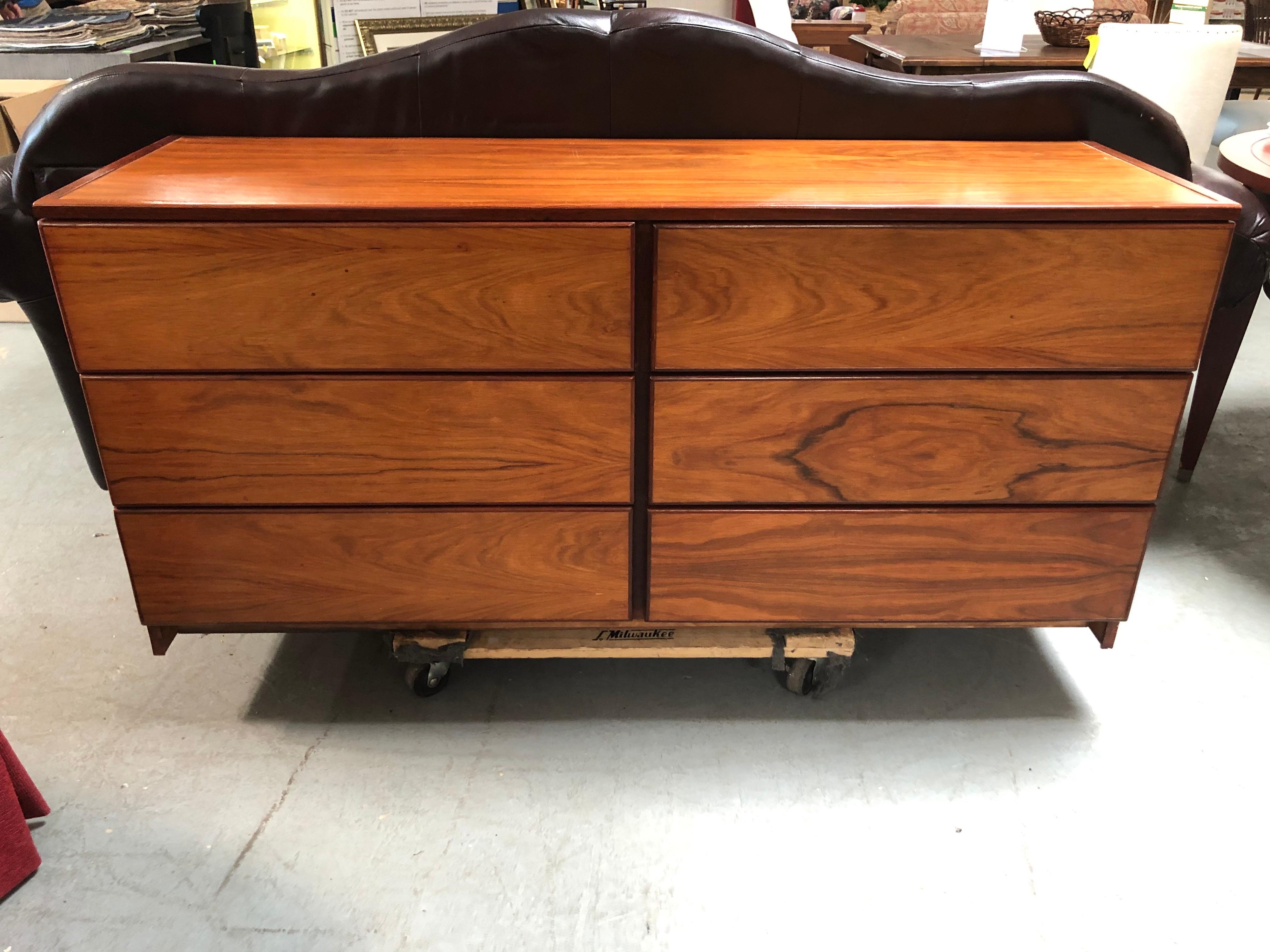 Mid Century Modern Six drawer rosewood dresser. Ample storage with a minimalist look. This rosewood dresser was custom made and is made from solid wood not a veneer. The drawers are all 6.50