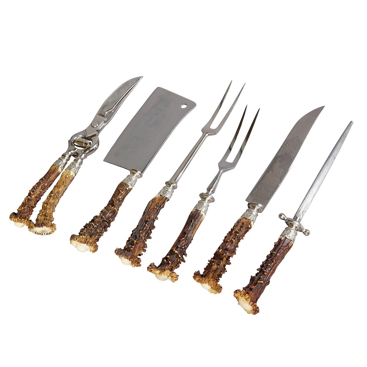Vintage Six Pieces Deer Horn Carving Set Solingen, Germany 1960s

A rustic six pieces carving set consisting of 2 forks, knife, axe, wing shears and honing steel. The handles are made of genuine deer horn. Blades and forks made of stainles steel and