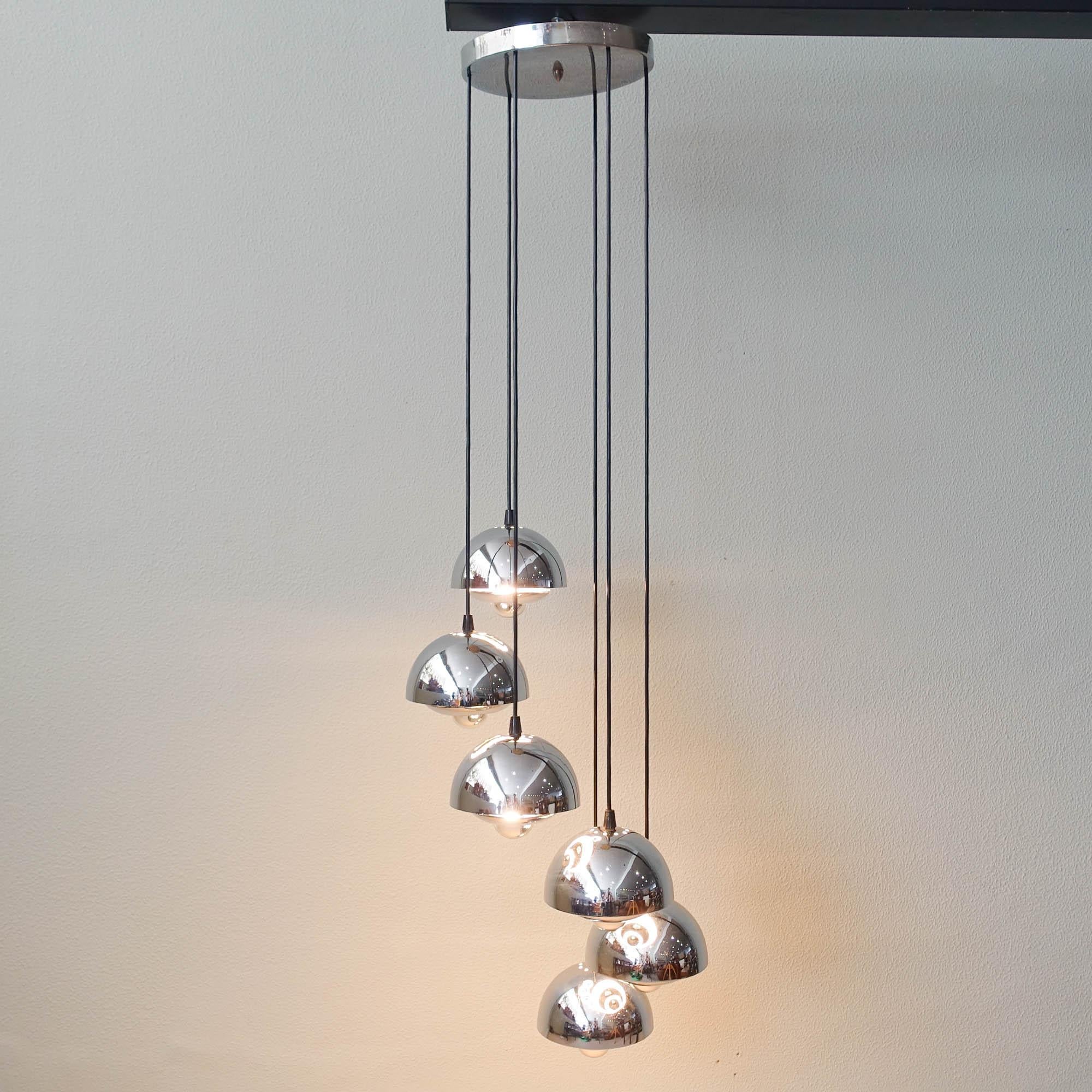 Cette lampe à cascade en métal chromé a été conçue et produite au Portugal dans les années 1970. Il comporte six boules en métal chromé, qui donnent une lumière indirecte lorsque les ampoules miroir appropriées sont utilisées. Hauteur réglable. Il