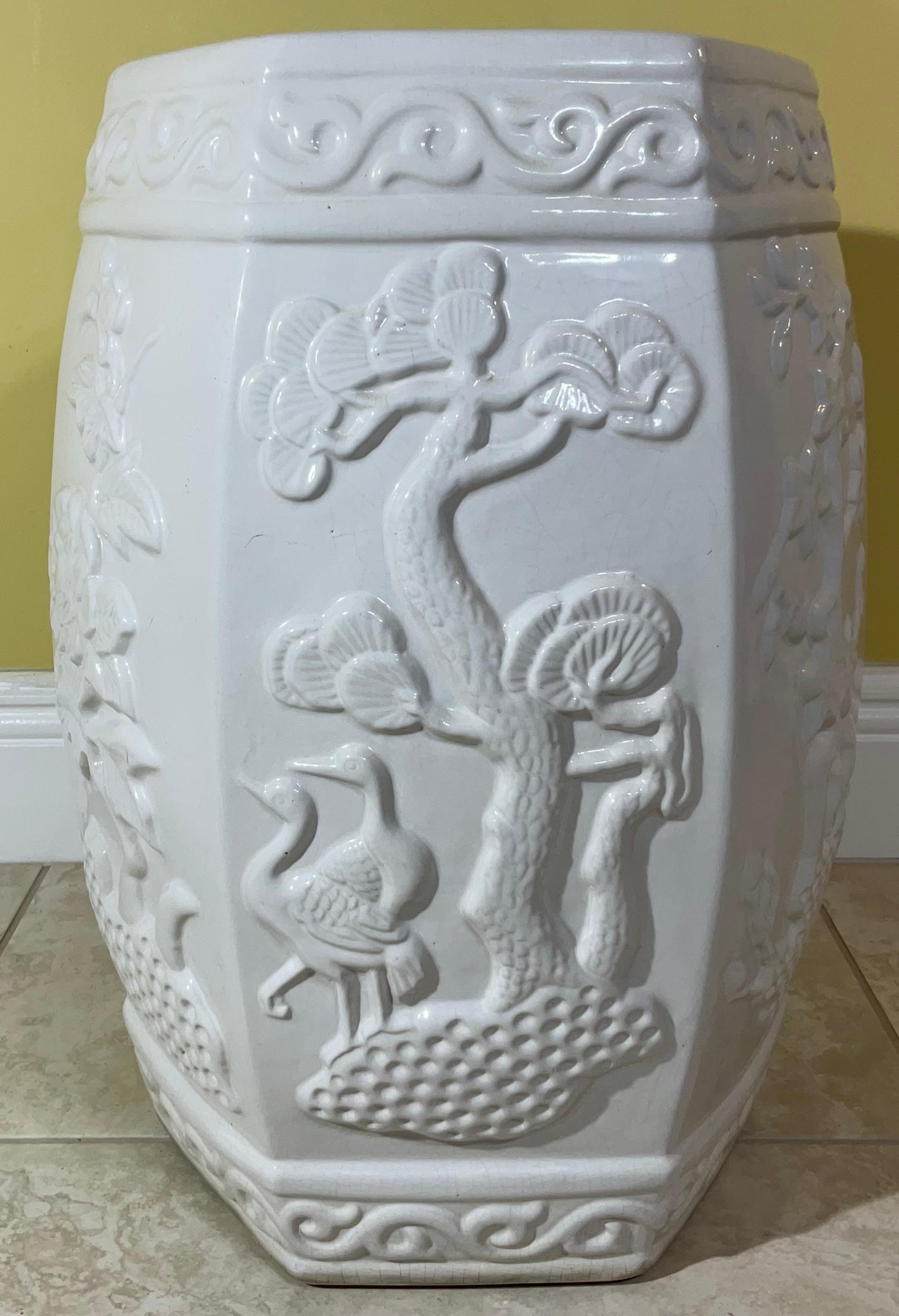 Very nice ceramic garden stool table is a classic Chinese six side form of garden decor in a good monochrome white glaze, decorated with bird flowers and plants motifs with top and bottom scroll band of Chinese decor. 
perfect pice to use indoors or