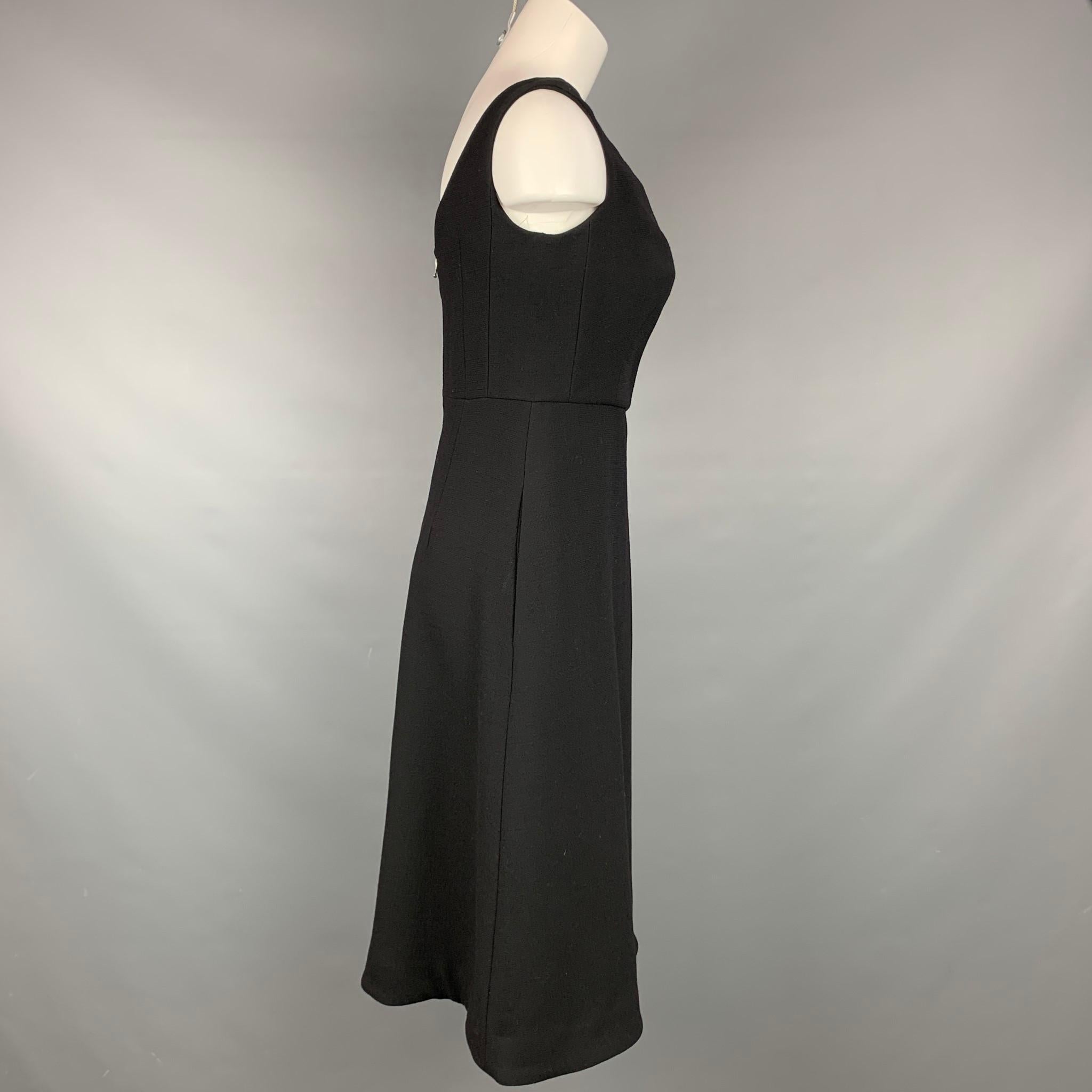 VINTAGE dress comes in a black acetate / viscose with a full liner featuring a v-neck, a-line, sleeveless, and a back zipper closure.

Good Pre-Owned Condition.
Marked: Size tag removed.

Measurements:

Bust: 30 in.
Waist: 28 in.
Hip: 35 in.
Length: