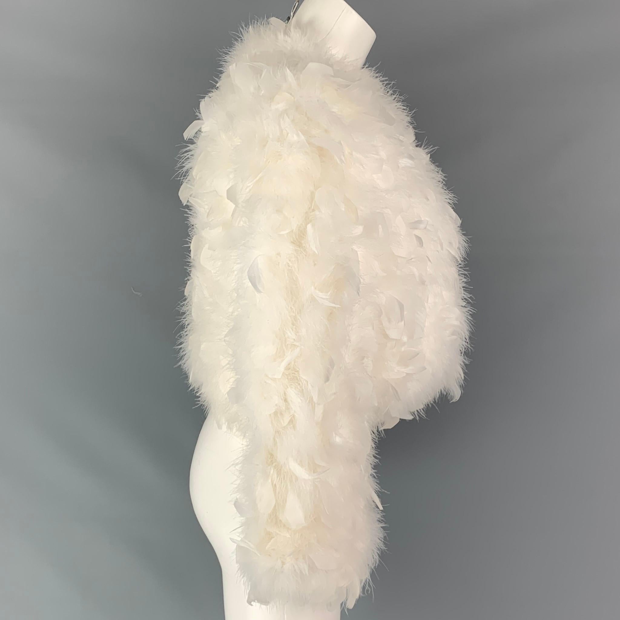 VINTAGE jacket comes in a cream nylon feather material with a full liner featuring a cropped style, collarless, and a hook & loop closure. 

Good Pre-Owned Condition.
Marked: S

Measurements:

Shoulder: 18 in.
Bust: 38 in.
Sleeve: 22.5 in.
Length: