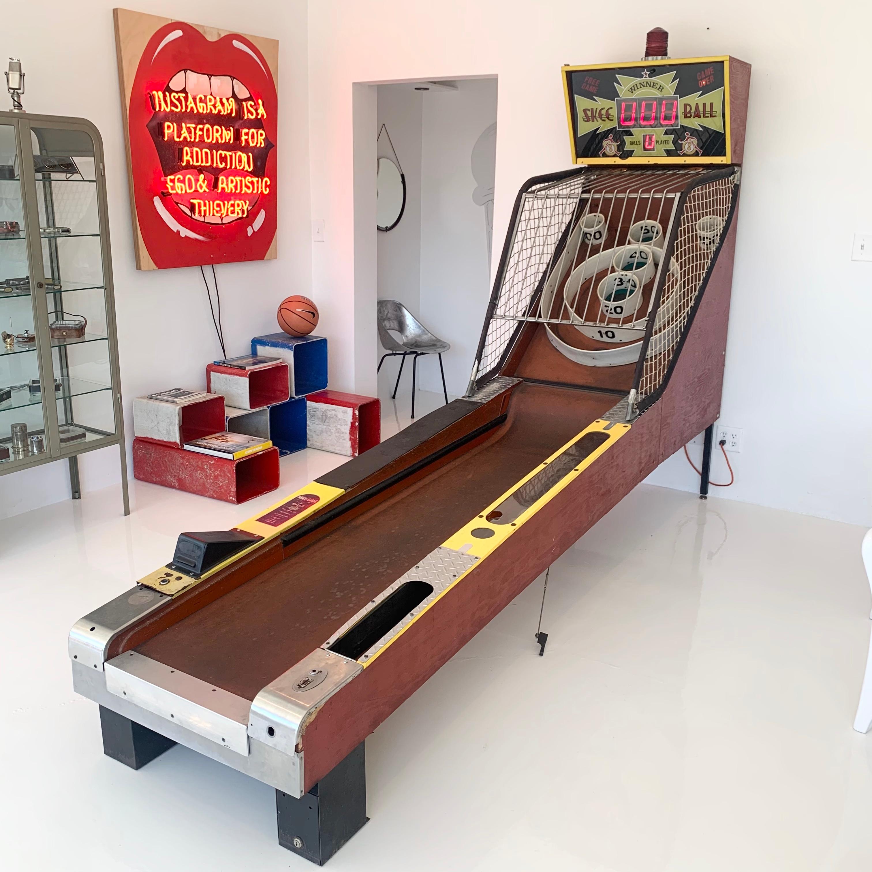 Cool vintage Skee-Ball machine in great working condition. Retired from a Redondo Beach, California arcade. 9 vintage wood balls included. Coin-operated with light up scoreboard. Just over 10 feet long. Everything works as it should. Wear