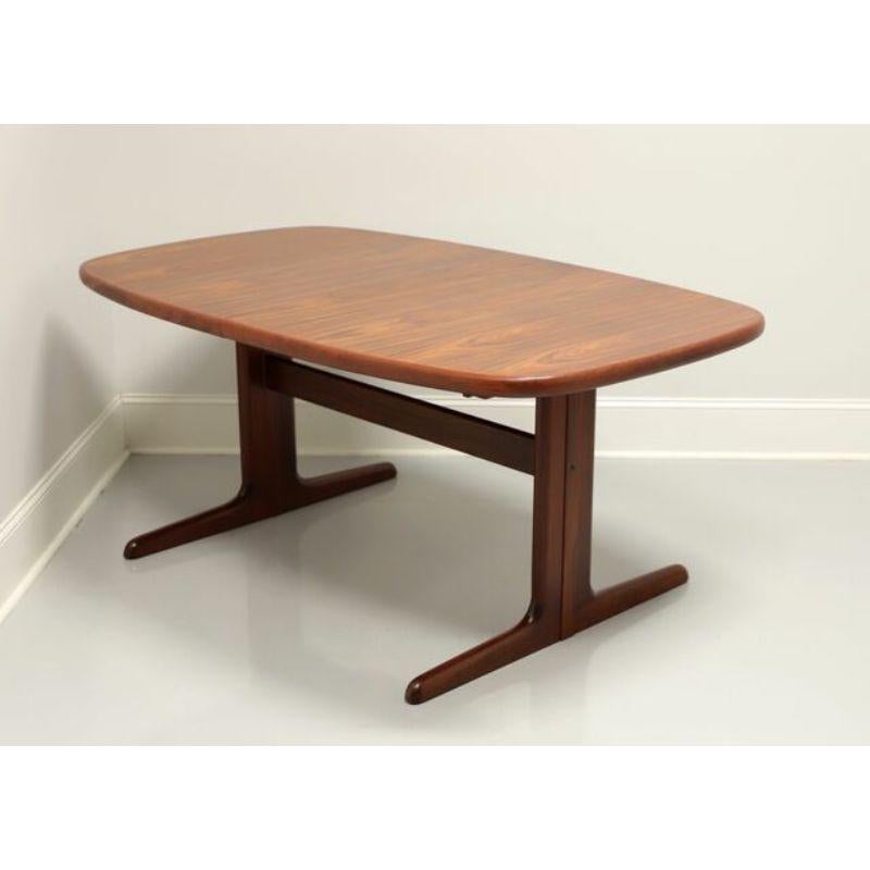 A tapered rectangular shaped dining table in the Danish Modern style by Skovby. Rosewood with a stunning grain to the top, smooth rounded apron and trestle style base. Includes one extension leaf. Made in Denmark, in the the mid-20th