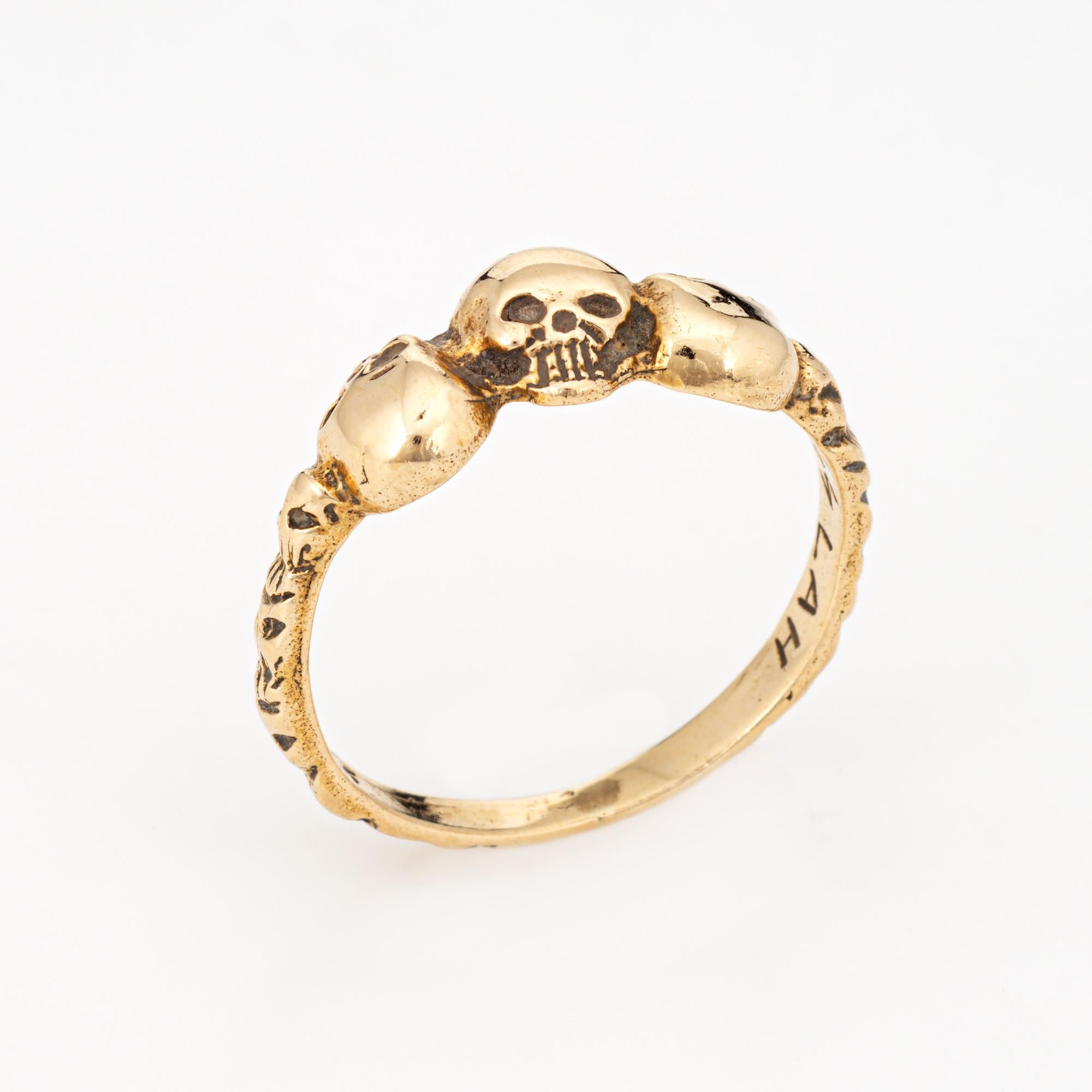 Stylish vintage skull ring crafted in 14 karat yellow gold. 

Three skull heads with the center set in opposing form adorn the band. The ring is great worn alone or stacked with your fine jewelry from any era.  

The ring is in very good condition.