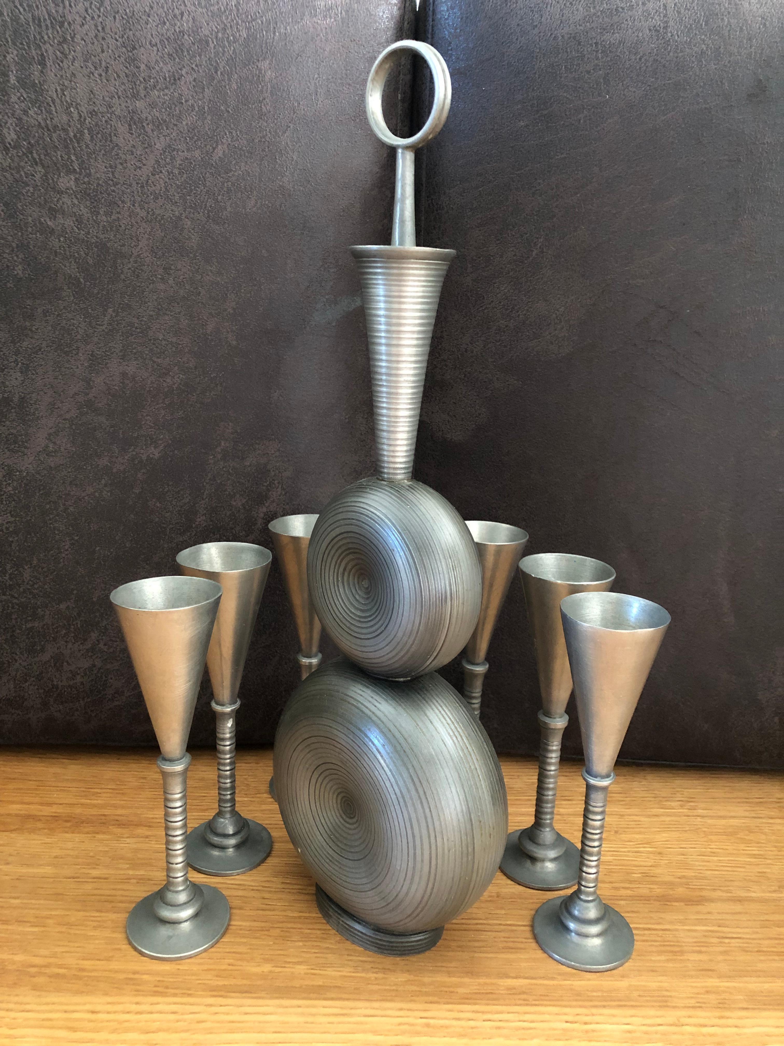 Great vintage Art Deco pewter decanter set by Gunnar Havstad Norway. Really beautiful styling on the decanter. Pieces are solid and have a nice weight. Set includes a decanter and six shot glasses. Please see photos carefully for details. Decanter