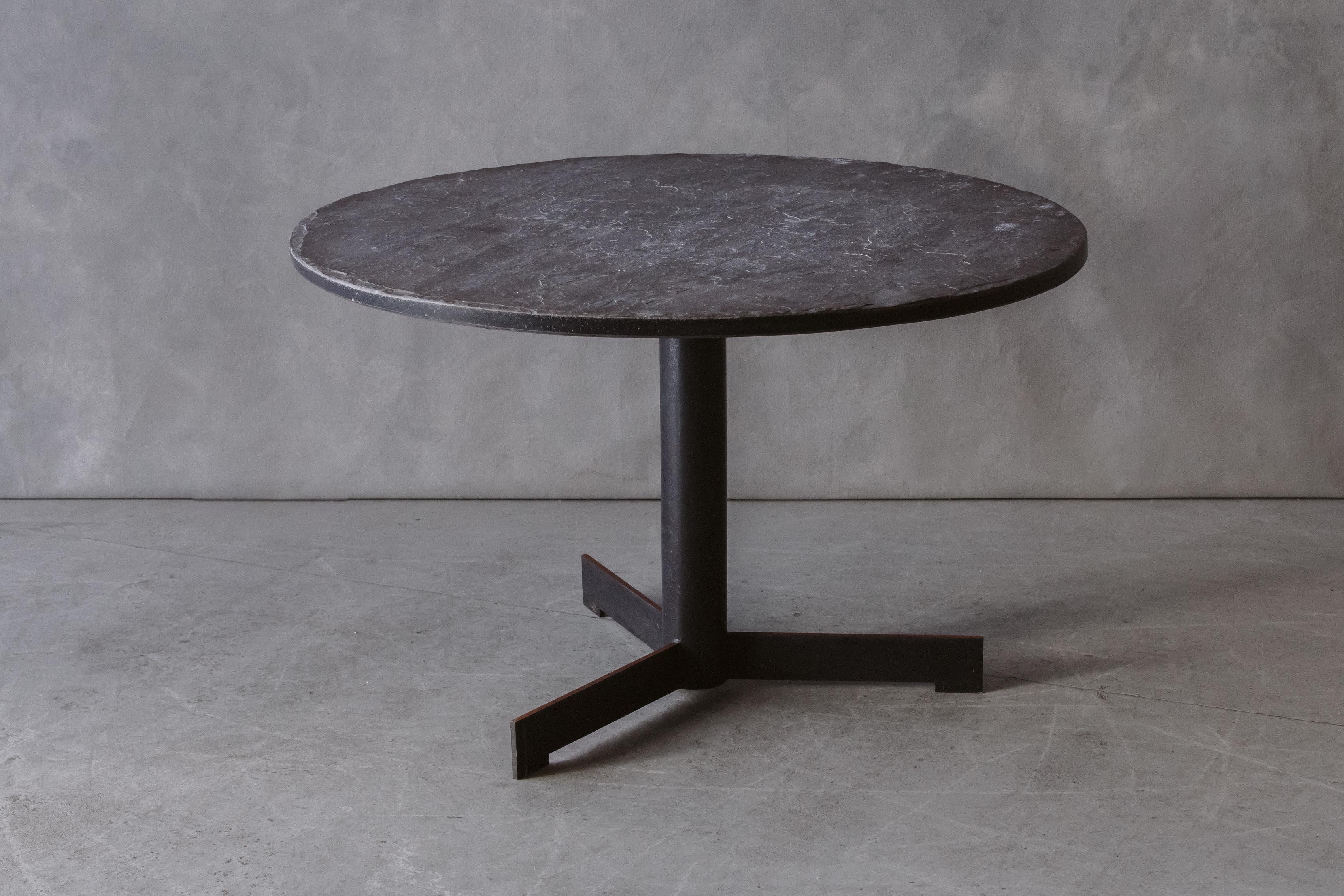 Vintage Slate Dining Table From Belgium, circa 1970s. Solid slate top on black steel base. Nice wear and use.

We prefer to speak directly with our clients. So, If you have any questions or would like to know more please give us a call or drop us