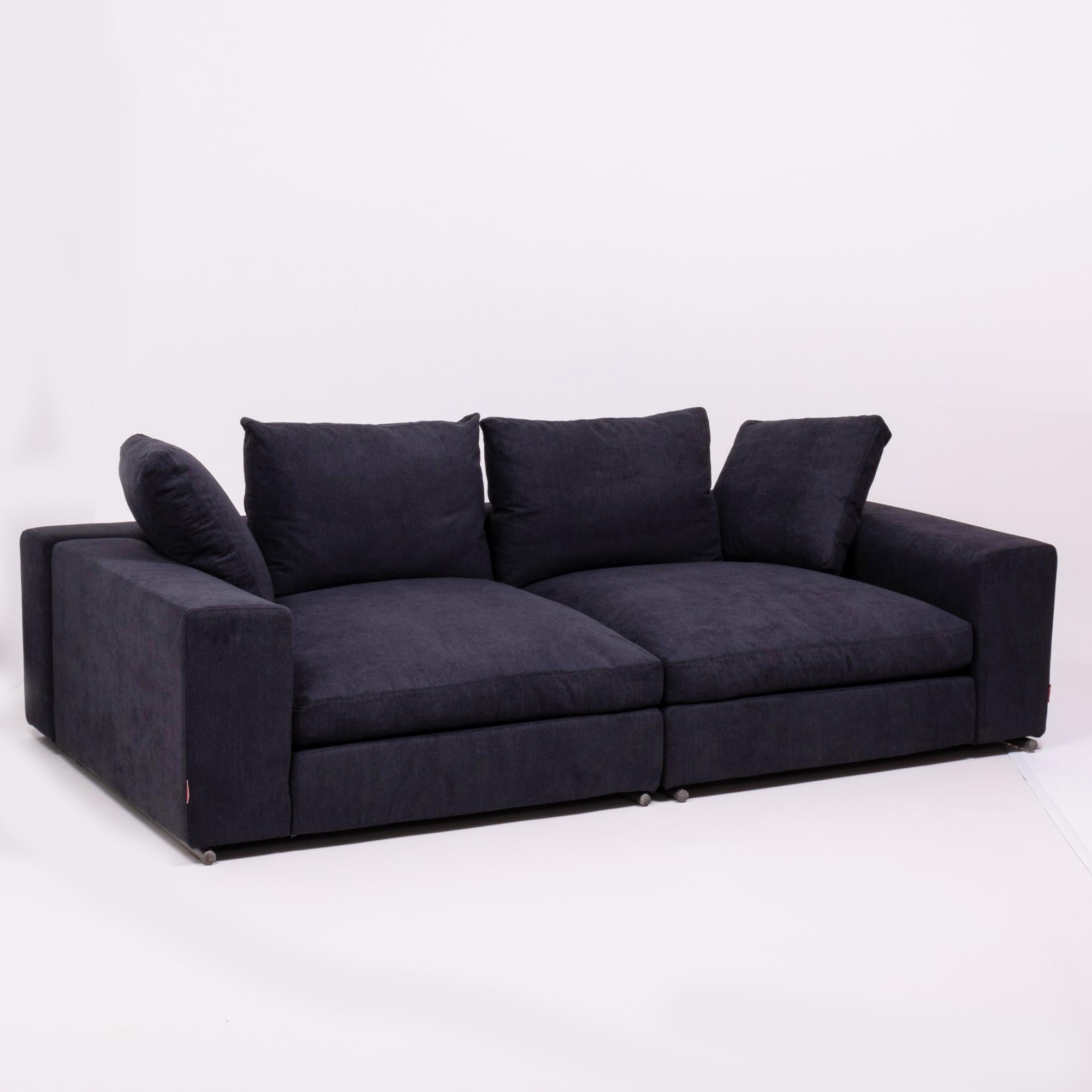 Exuding style and comfort, this sectional sofa made by Flexform has been newly reupholstered in a slate grey Linara fabric.

Comprising of two separate units, the sofa has a thick block-like frame and tubular metal feet.

The two seat cushions,