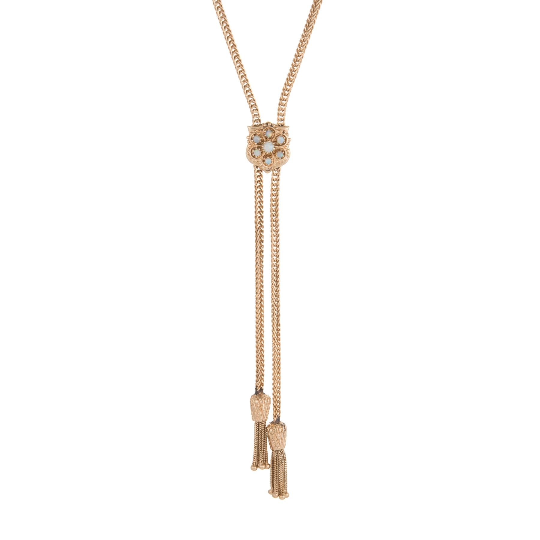 Elegant and finely detailed slide necklace, crafted in 14 karat yellow gold.  

One approx. 0.15 carat opal is accented with a further six approx. 0.10 carat opals The total opal weight is estimated at 0.75 carats. The opals are in excellent