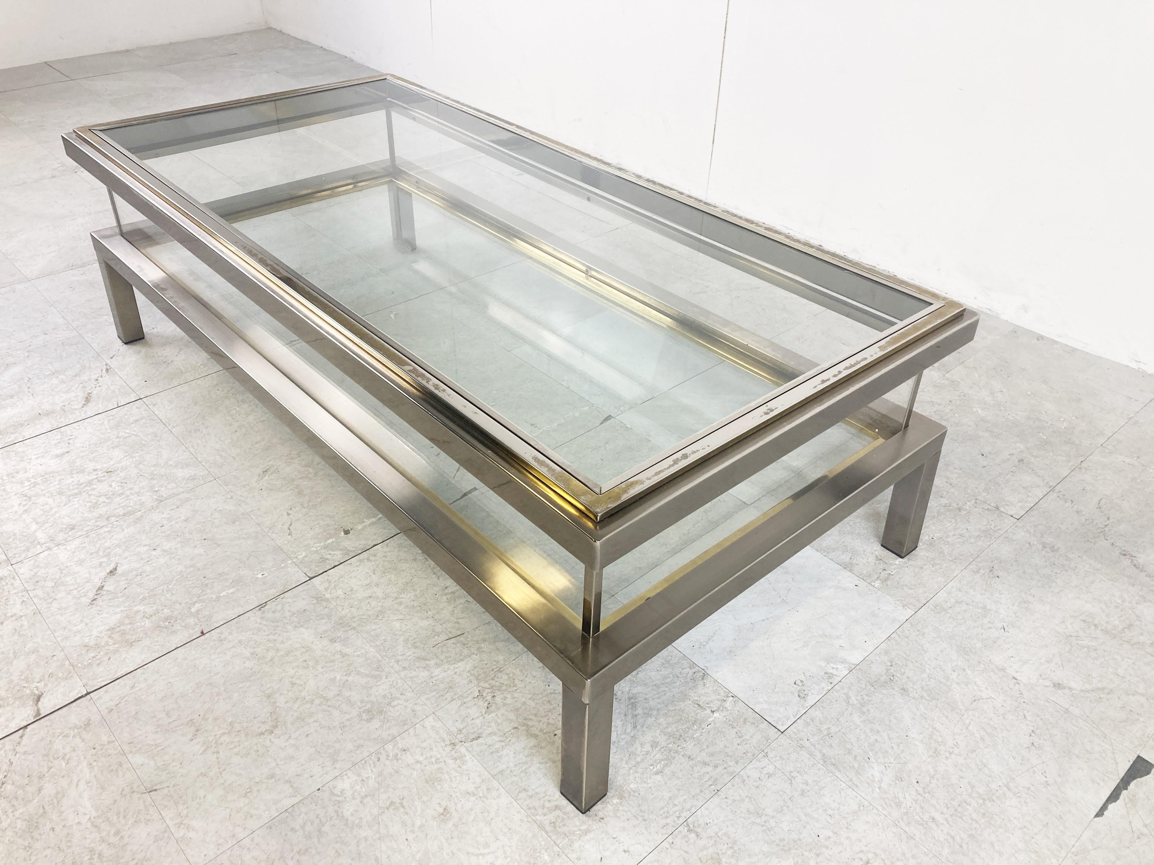 Vintage display coffee table with a sliding glass top.

This luxurious coffee table is made from brass, glass top and bottom and plexiglass sides.

It is ideal to display curio and store magazines,...

The brass on top is faded but overall the