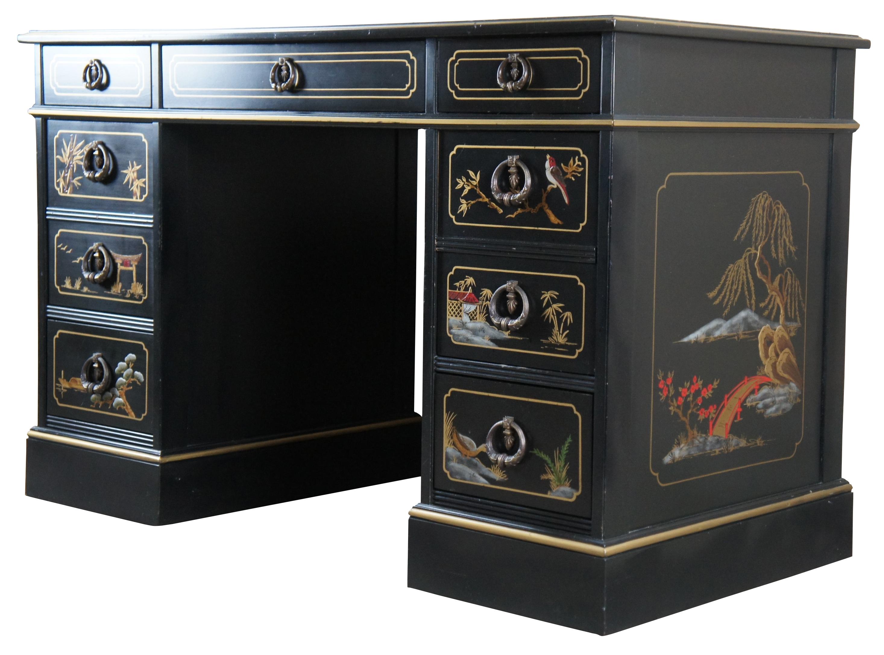 Vintage Sligh Furniture black lacquered knee hole writing desk featuring Chinoiserie styling with seven drawers, a tooled red leather top, and floral landscape motif that features birds, bridges, boats, pagodas and bamboo.

Measures: 46