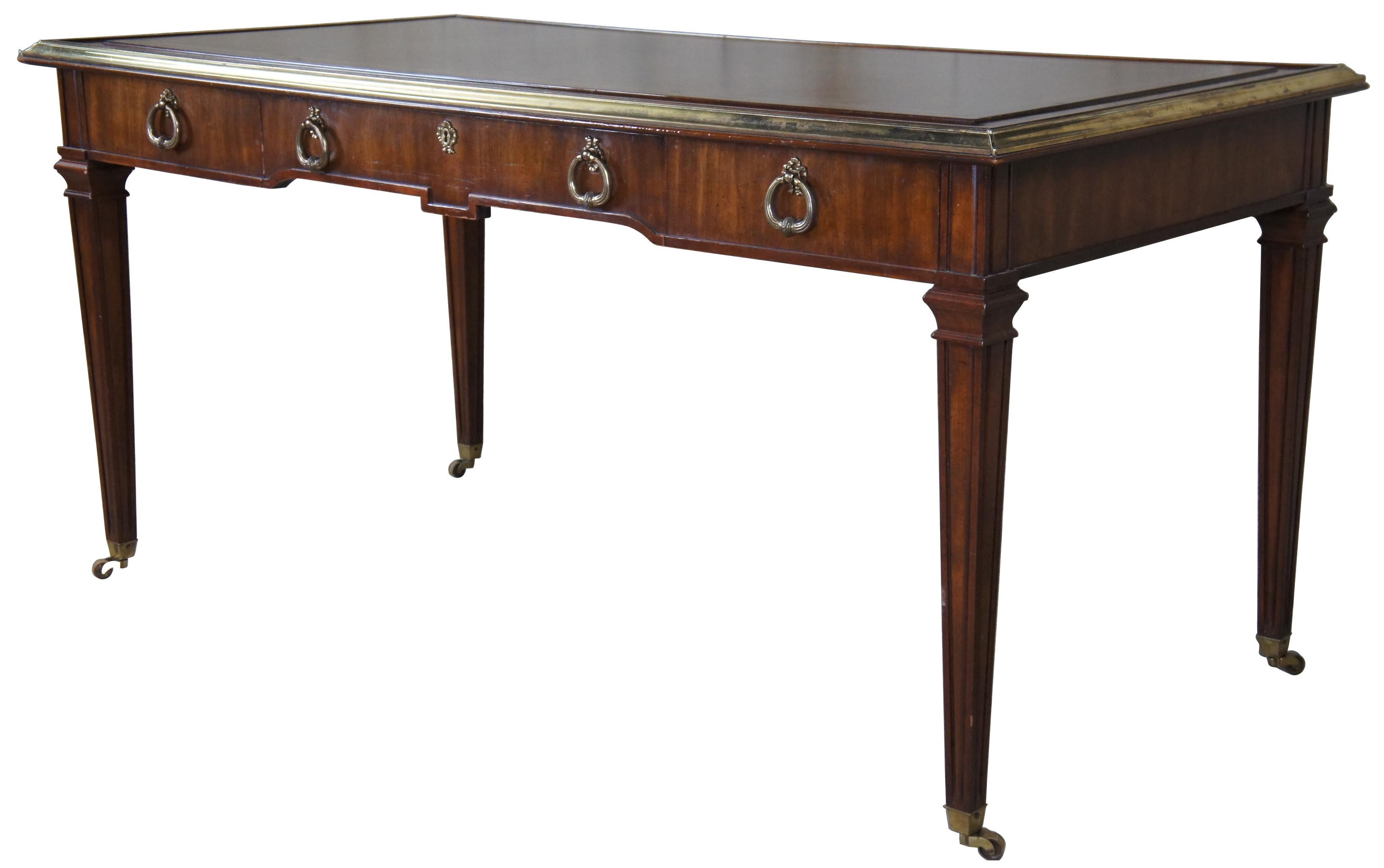 Vintage Sligh Furniture writing desk. Made of mahogany with brass edgework, tooled leather top featuring Greek key, fleur de lis, repeating spades and neoclassical drawer pulls.
 