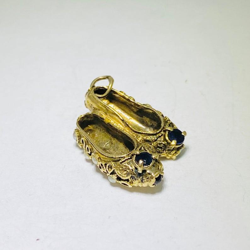 The intricate ballet slipper shoe charm is a work of art and special, custom fine jewelry piece! This charm is an estate piece (Circa 1950) and made in 10 karat yellow gold. This slipper shoes have hand craftsmanship, filigree and scroll work around